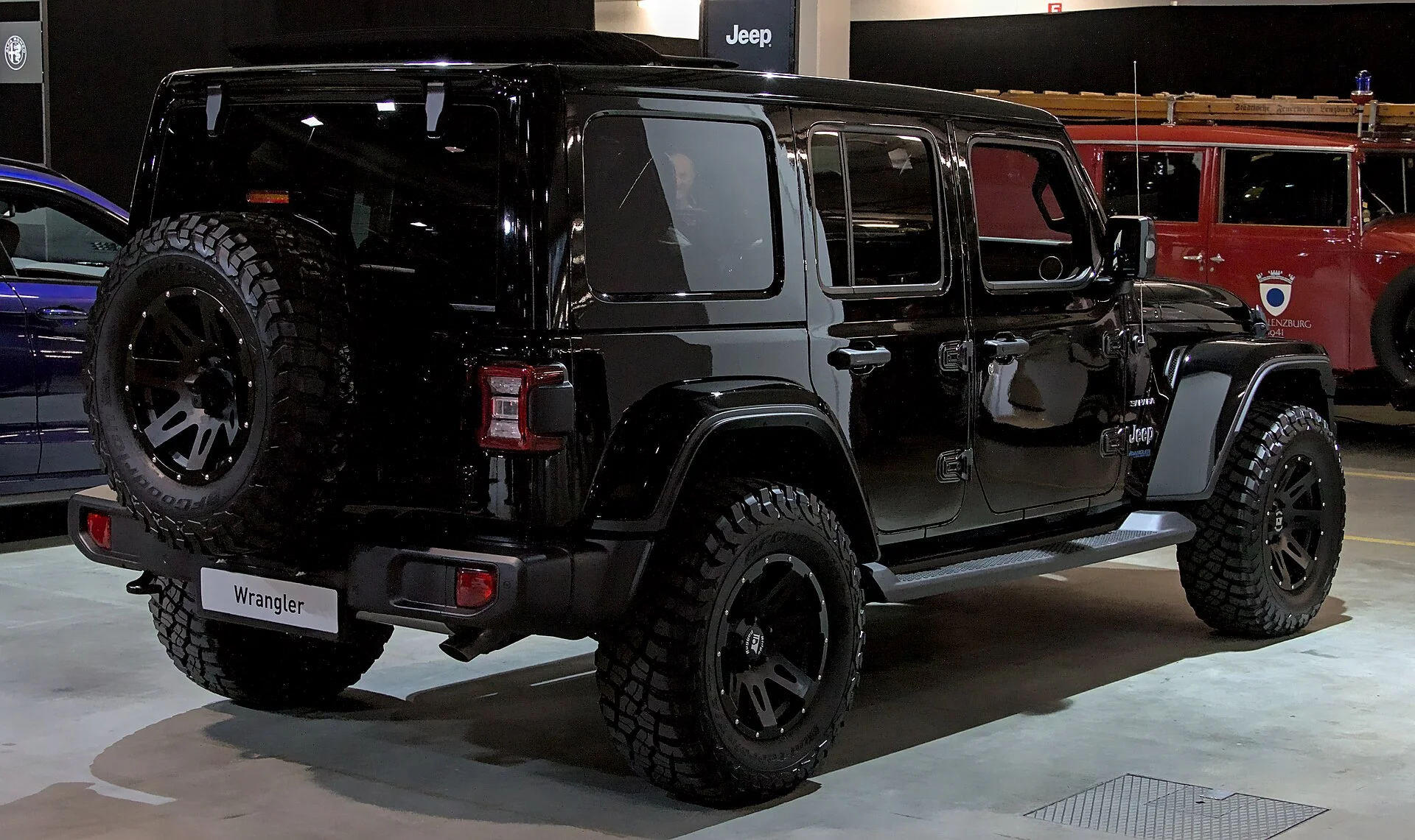 Jeep Wrangler Unlimited Sahara — a black Wrangler 4xe, rear three-quarter view