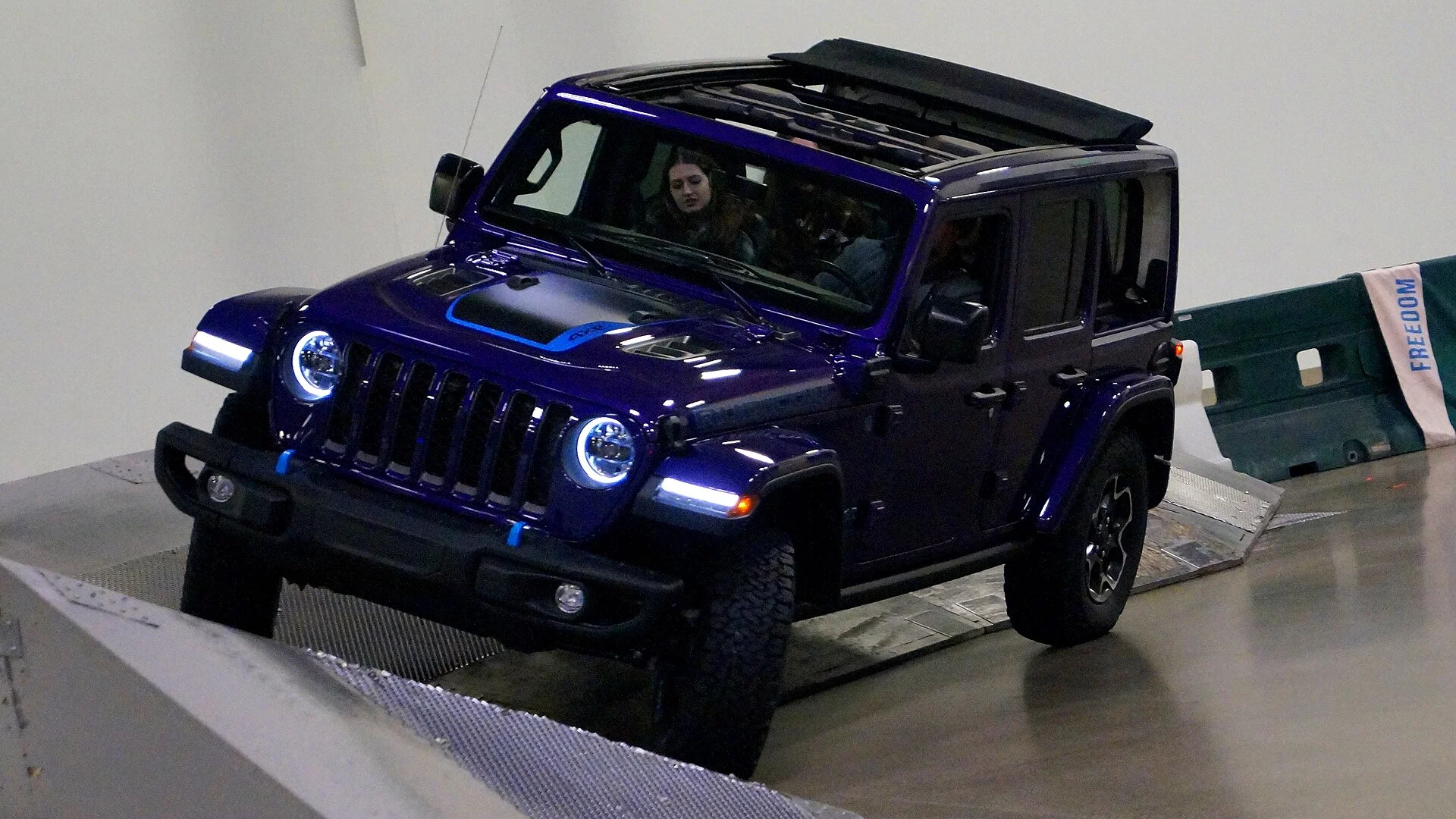 Jeep Wrangler Rubicon — a 2023 Wrangler angled on a display ramp