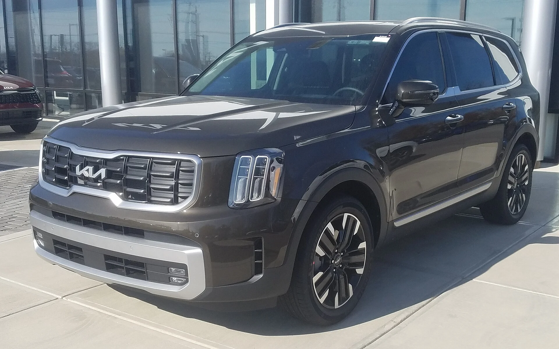 Kia Telluride — a dark-brown 2023 Telluride, front three-quarter view