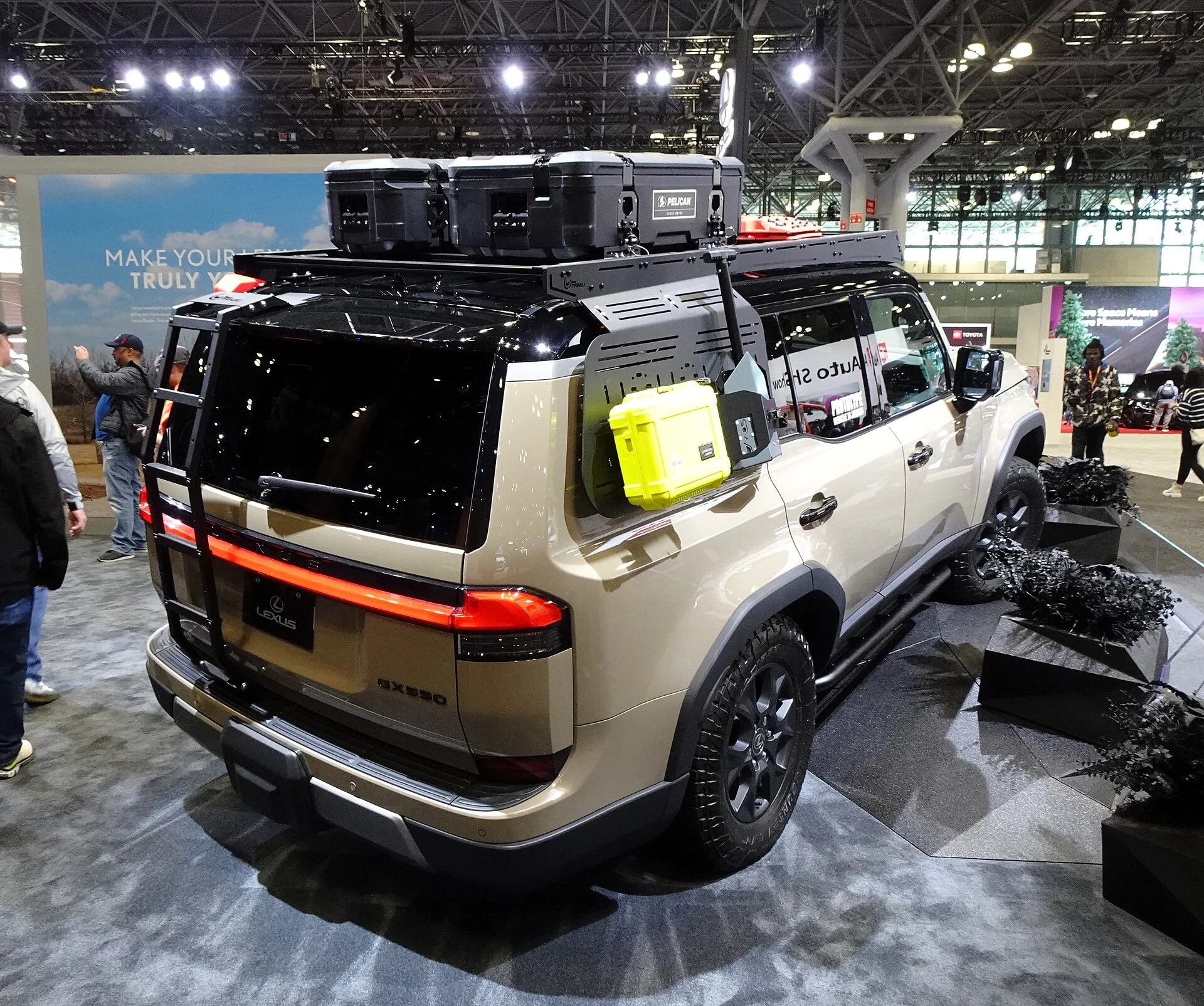 A Lexus GX 550 Overtrail fitted with a roof rack and cargo boxes (rear view), directly illustrating roof rack options.