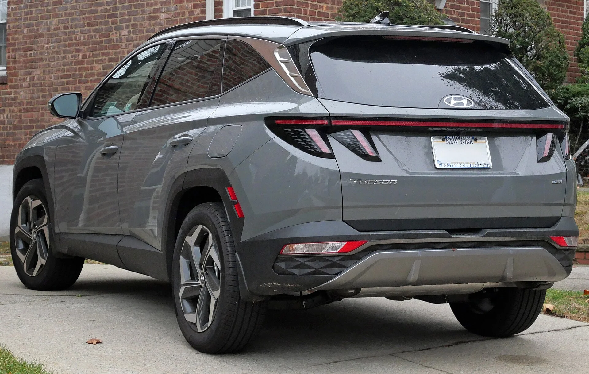 A Hyundai Tucson (NX4) rear three-quarter, the liftgate and cargo end you fold flat to maximize sleeping length