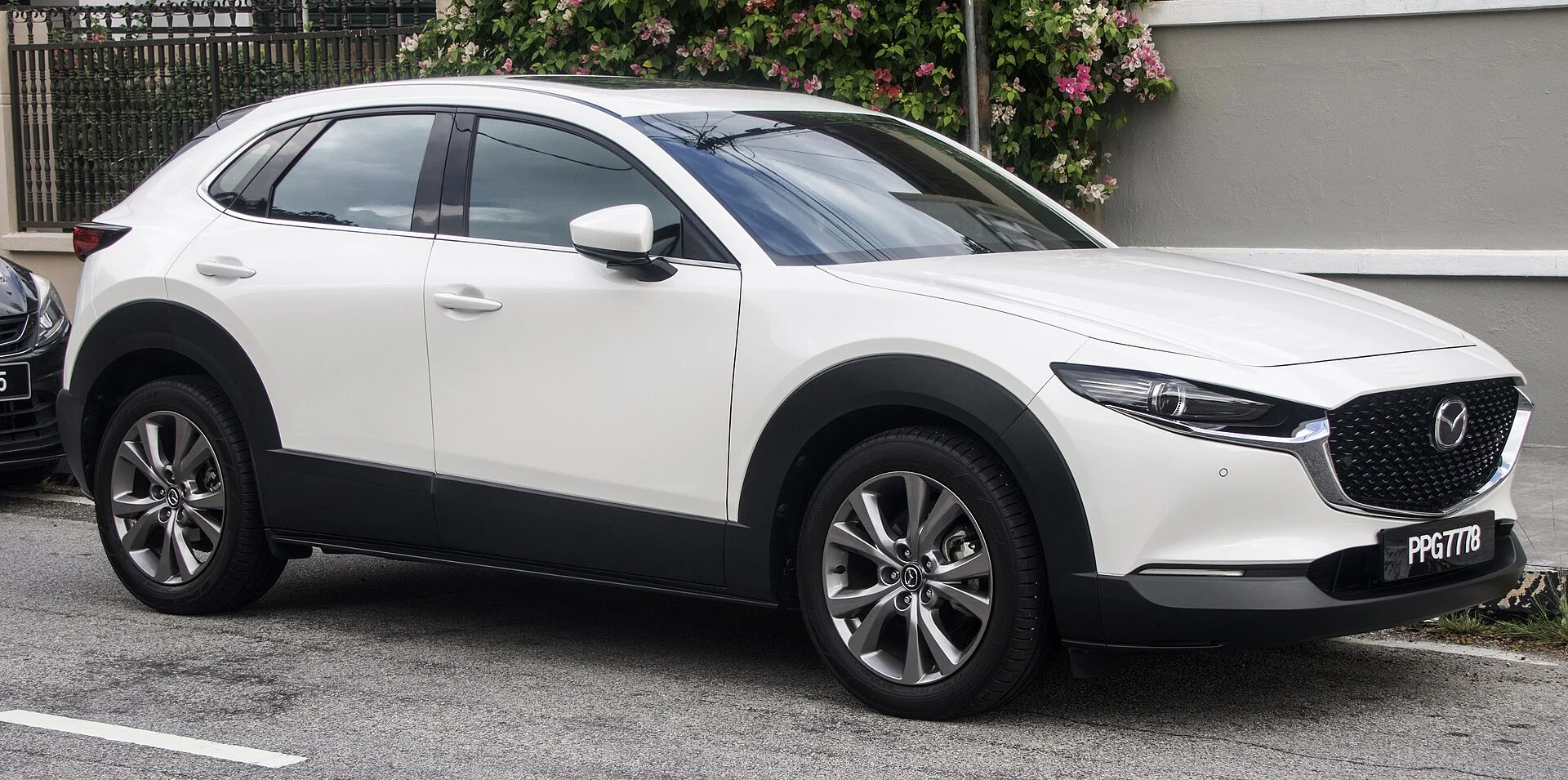 A Mazda CX-30 subcompact SUV (front view), the vehicle this camping accessories guide covers.