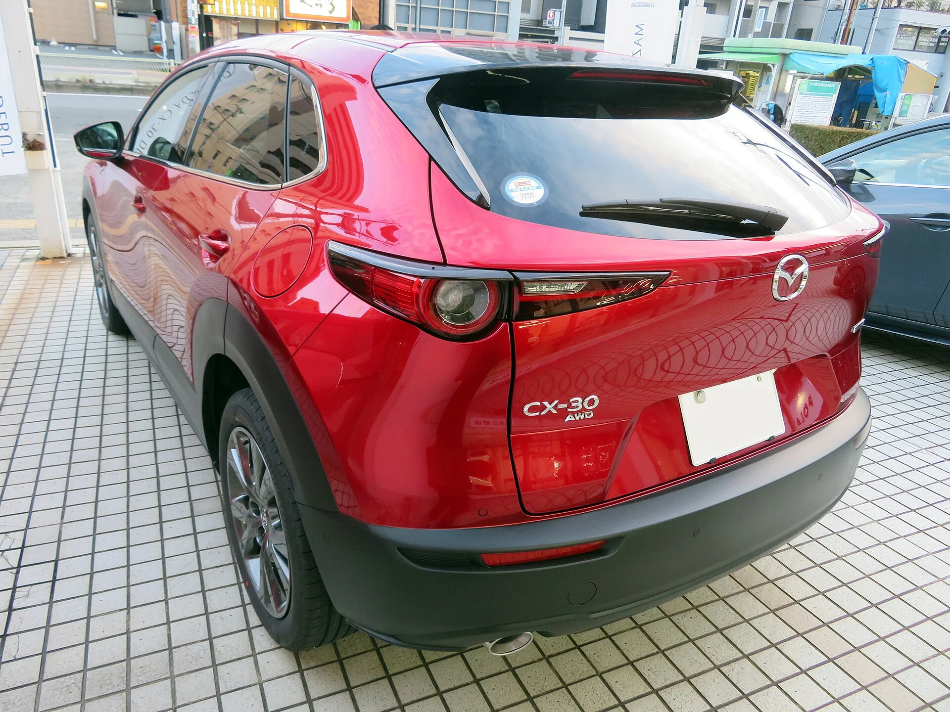 A Mazda CX-30 (rear three-quarter view), showing the tailgate and cargo access used for camping.