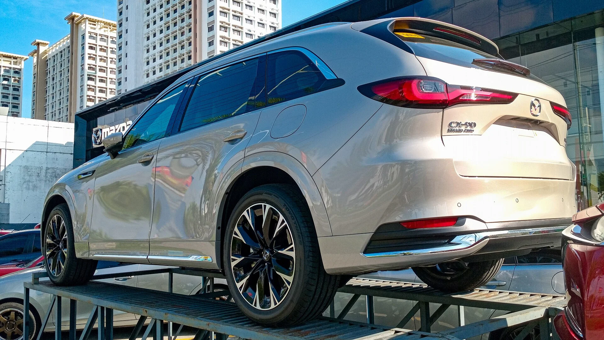 A Mazda CX-90 rear three-quarter, the liftgate and cargo area you fold down for sleeping