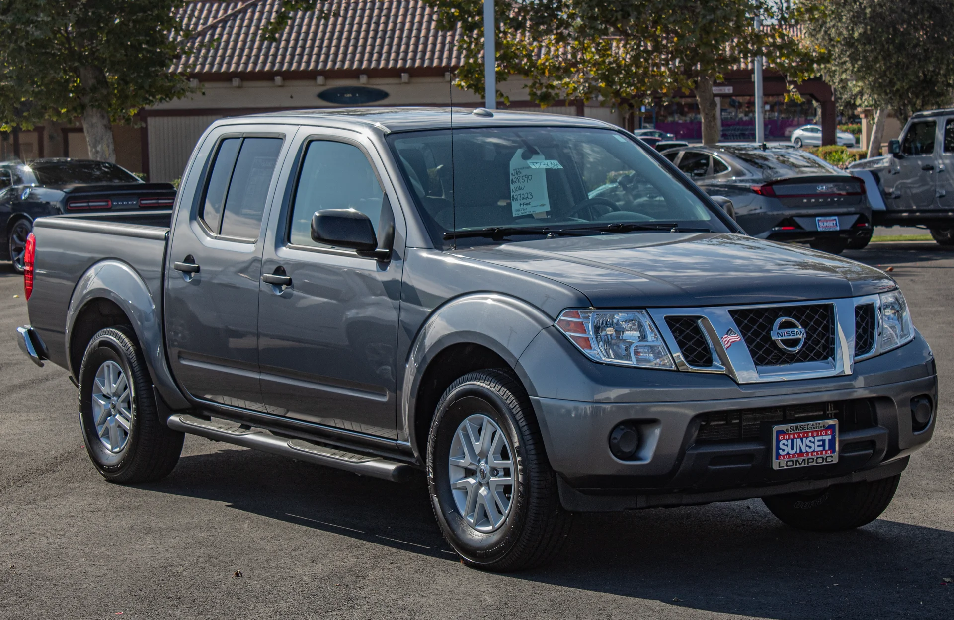 Grey Nissan Frontier crew cab, front three-quarter view