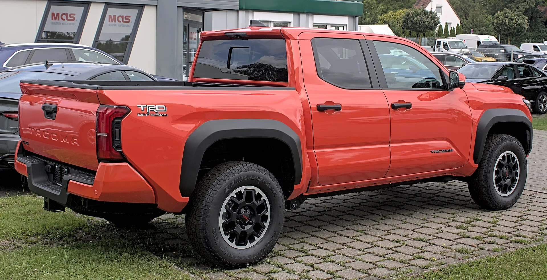 Red Toyota Tacoma TRD, current generation, rear three-quarter view