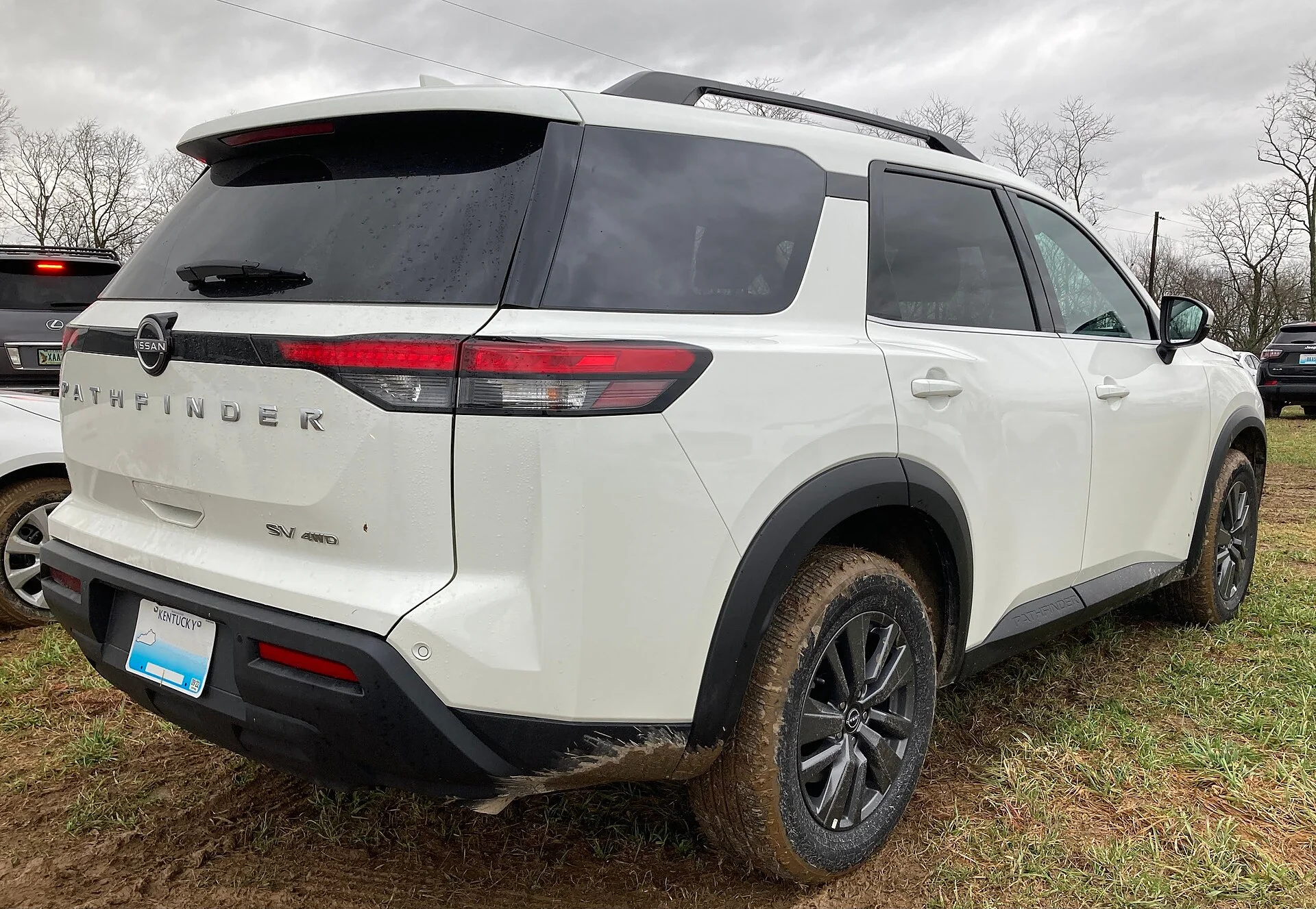 Nissan Pathfinder SV — a white 2022 Pathfinder, rear view