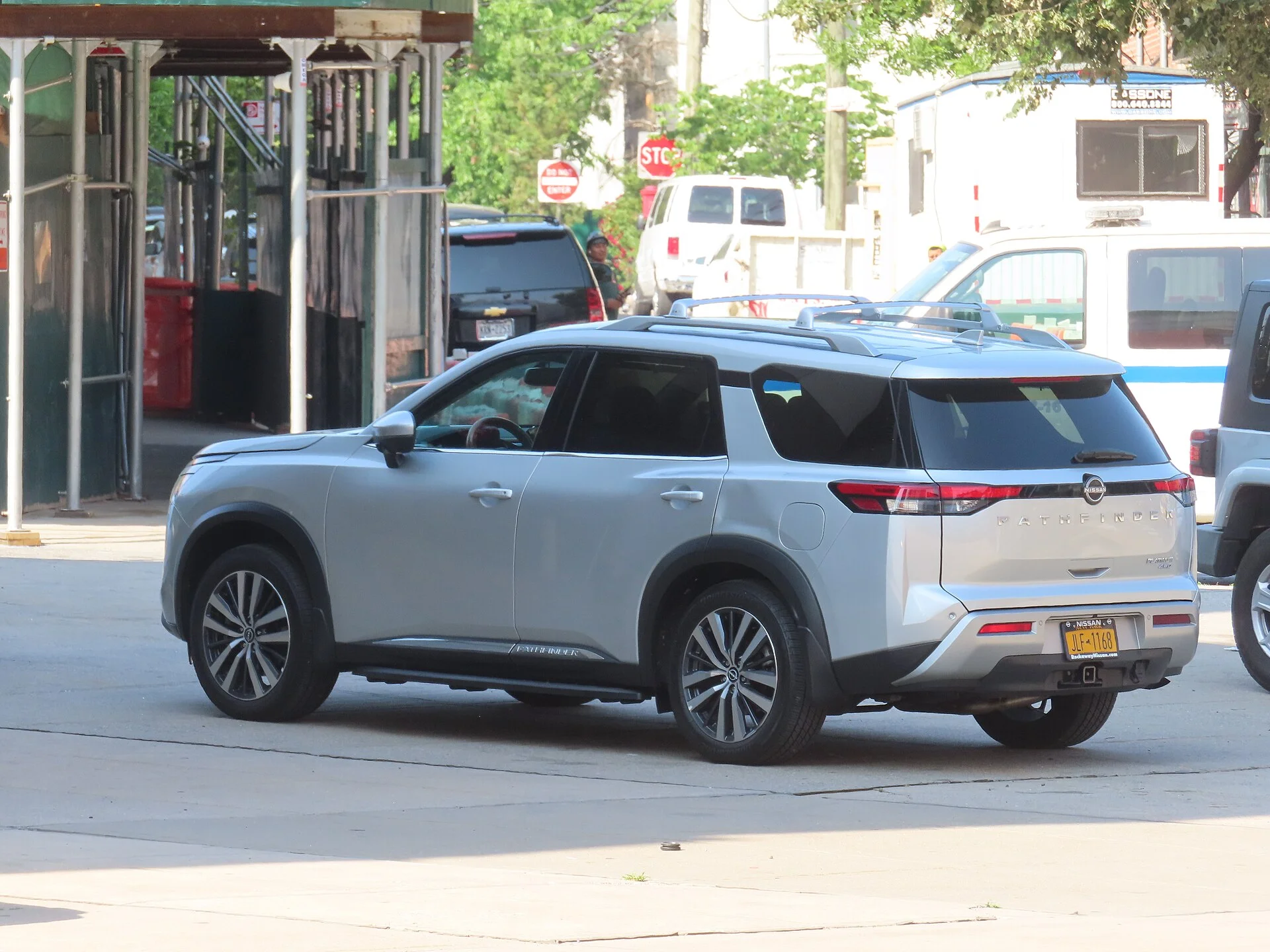 Nissan Pathfinder — a silver 2023 Pathfinder, rear three-quarter view
