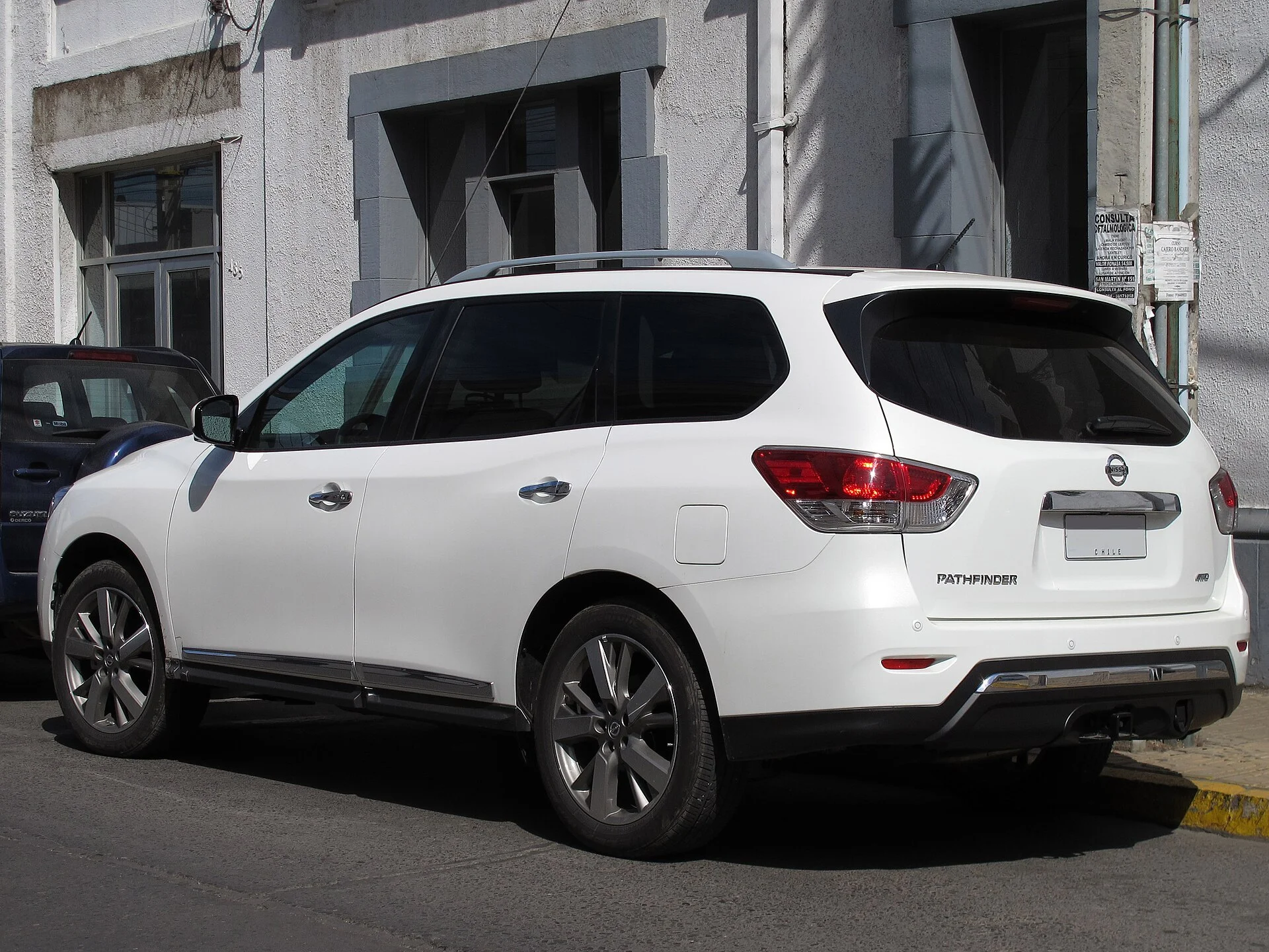Nissan Pathfinder — a white 2014 (previous-generation) Pathfinder, rear three-quarter view