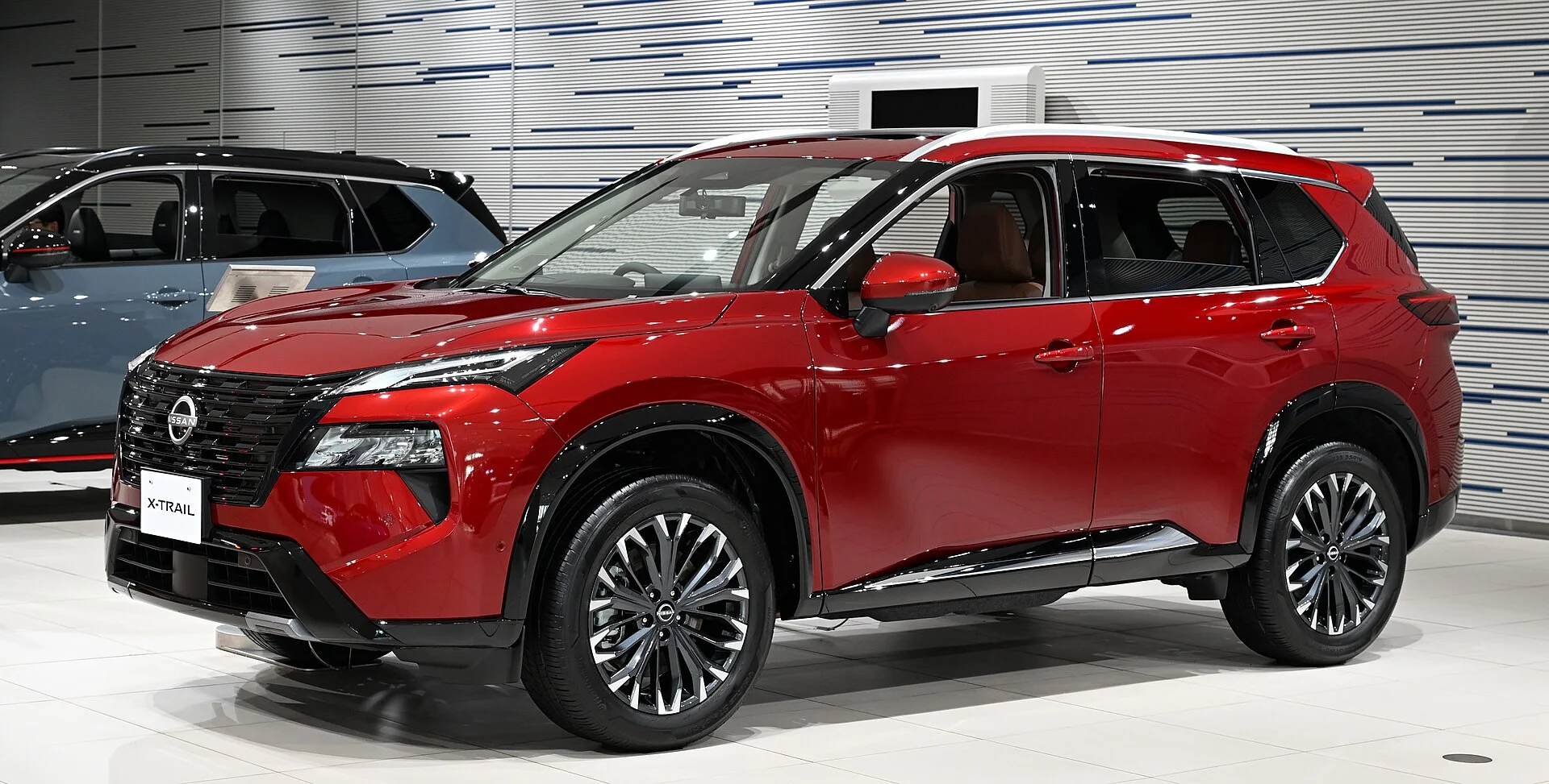 Red Nissan Rogue, current generation, front three-quarter view