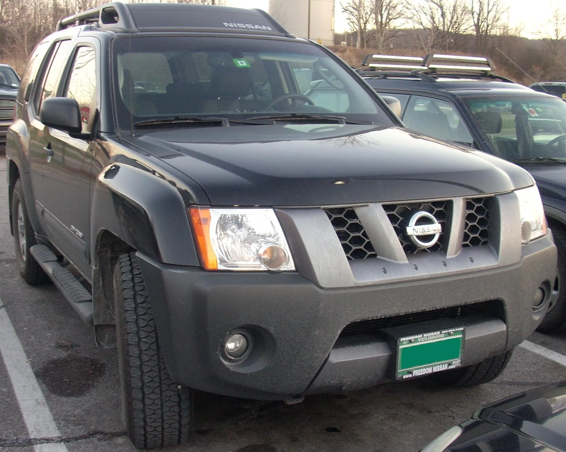 Nissan Xterra — a red Xterra off-road trim, front three-quarter view