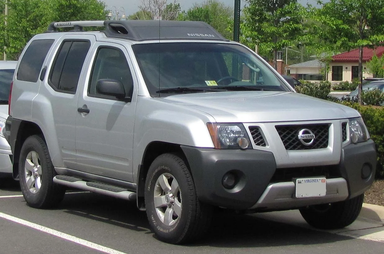 Nissan Xterra — a silver 2010 Xterra, front three-quarter view