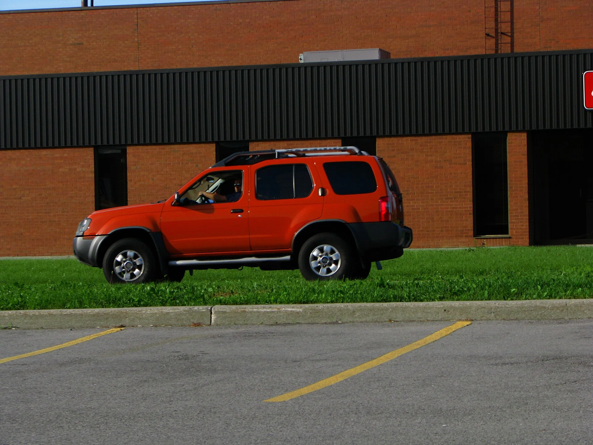 Nissan Xterra — an orange Xterra, side three-quarter view