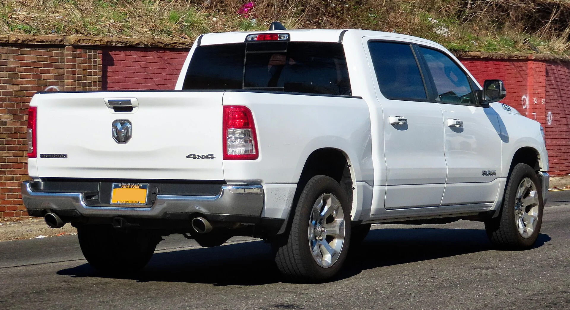 Ram 1500 Bighorn — a white 2019 Ram 1500, rear three-quarter view