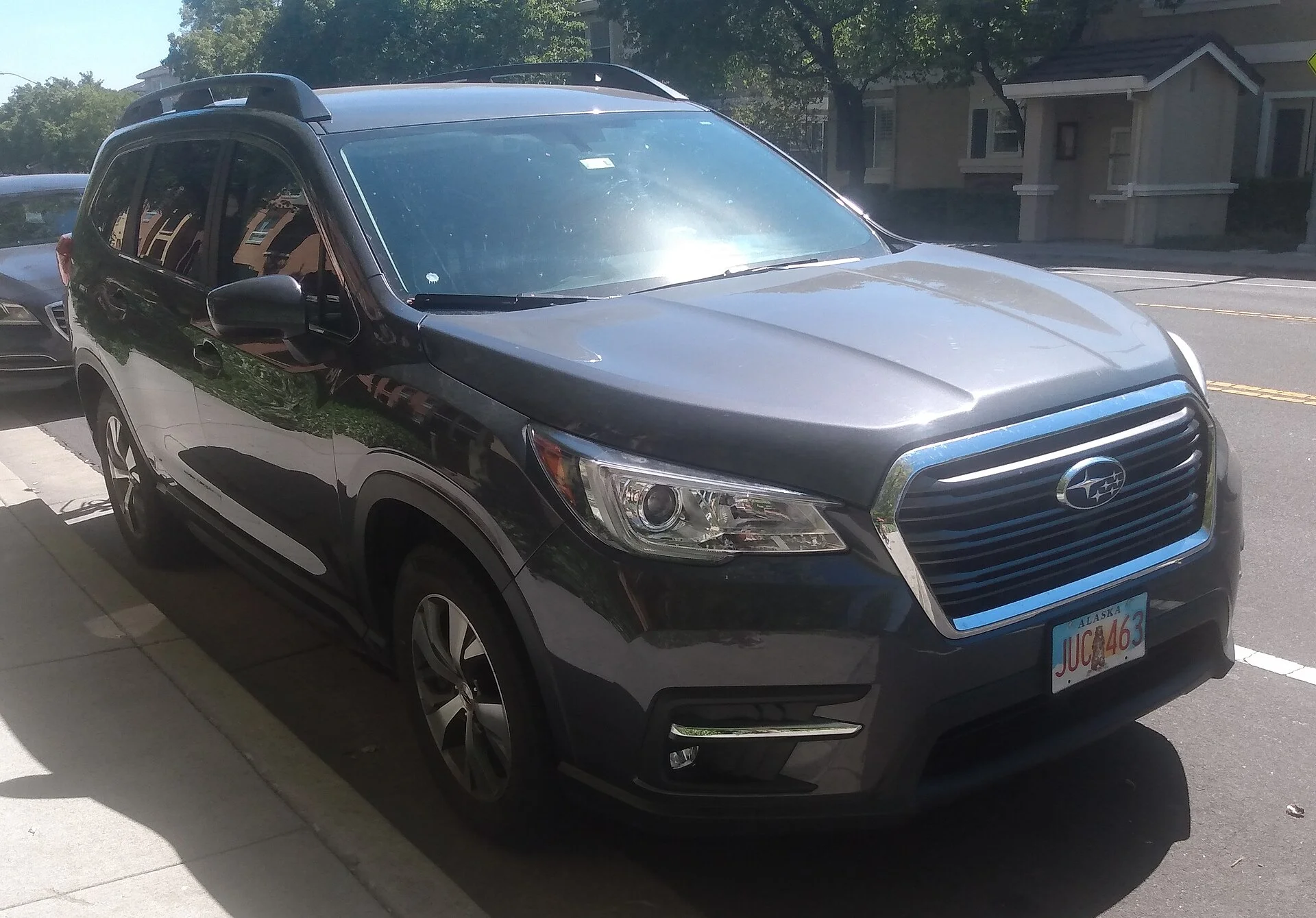 Subaru Ascent Touring — a dark-grey 2020 Ascent, front and side three-quarter view showing the roof rails