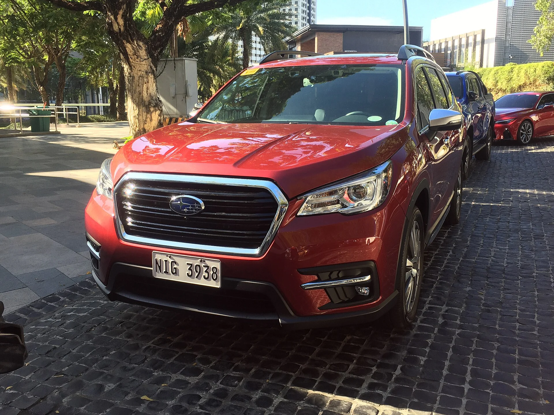 Subaru Ascent Touring — a red Ascent, front three-quarter view with roof rails