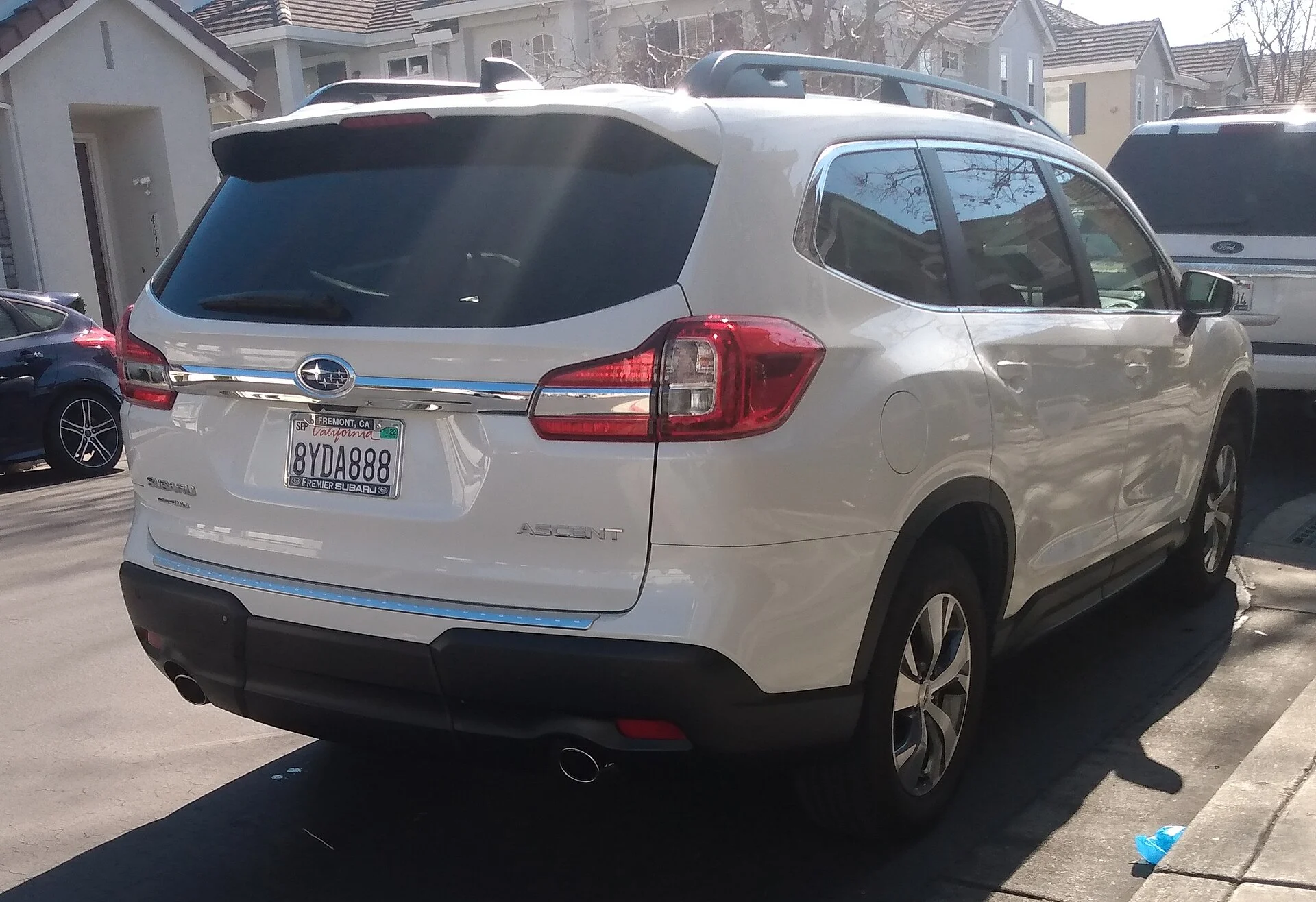 Subaru Ascent — a white 2019 Ascent, rear three-quarter view with roof rails