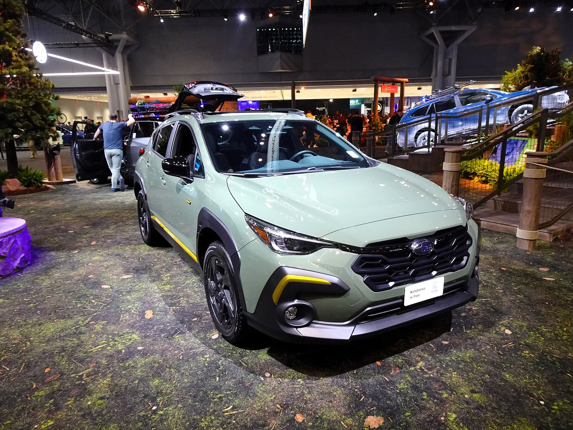 A Subaru Crosstrek Sport (front view) in green, one of the current Crosstrek trims this camping guide discusses.