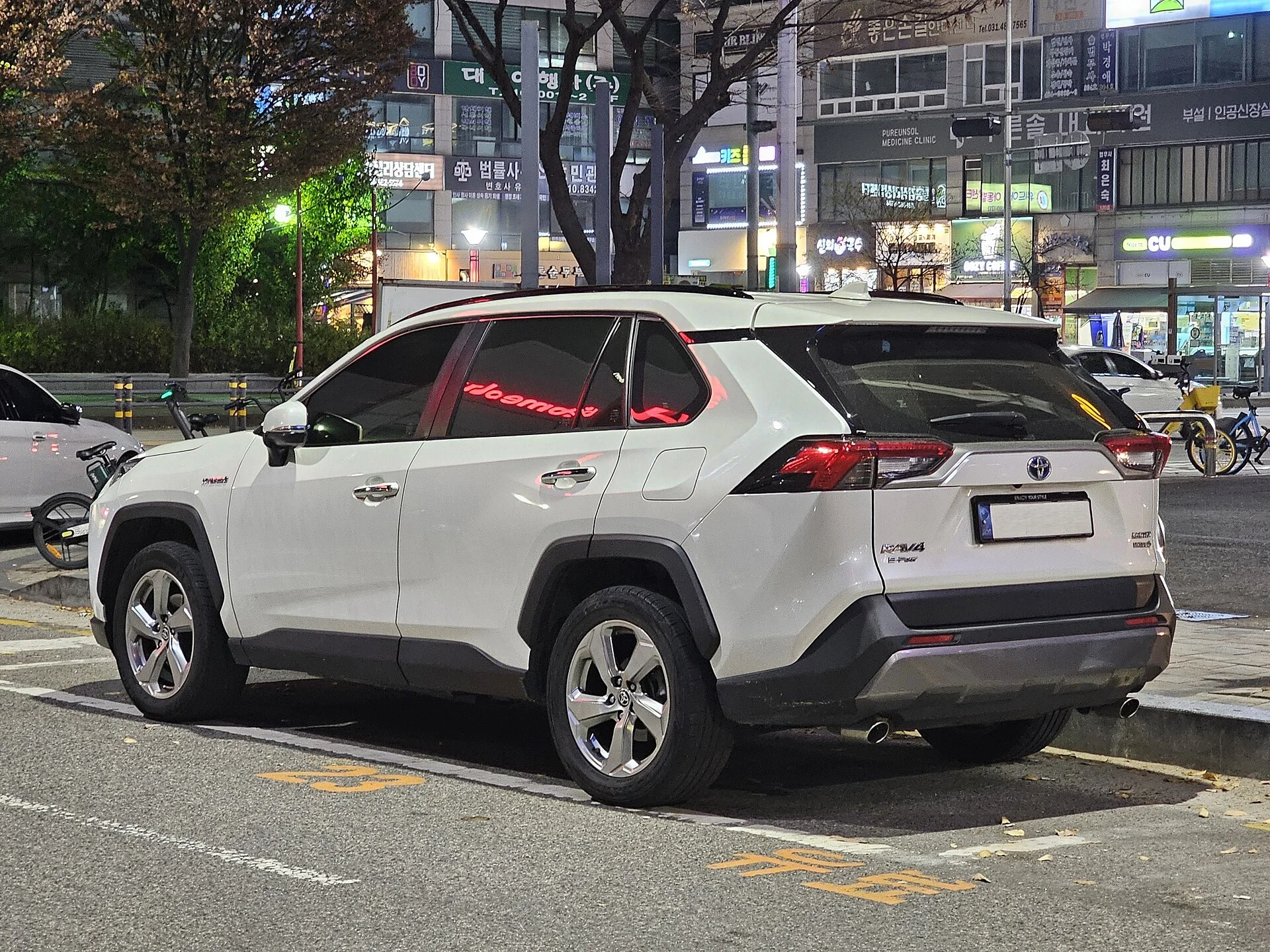 White Toyota RAV4, current generation, rear three-quarter view