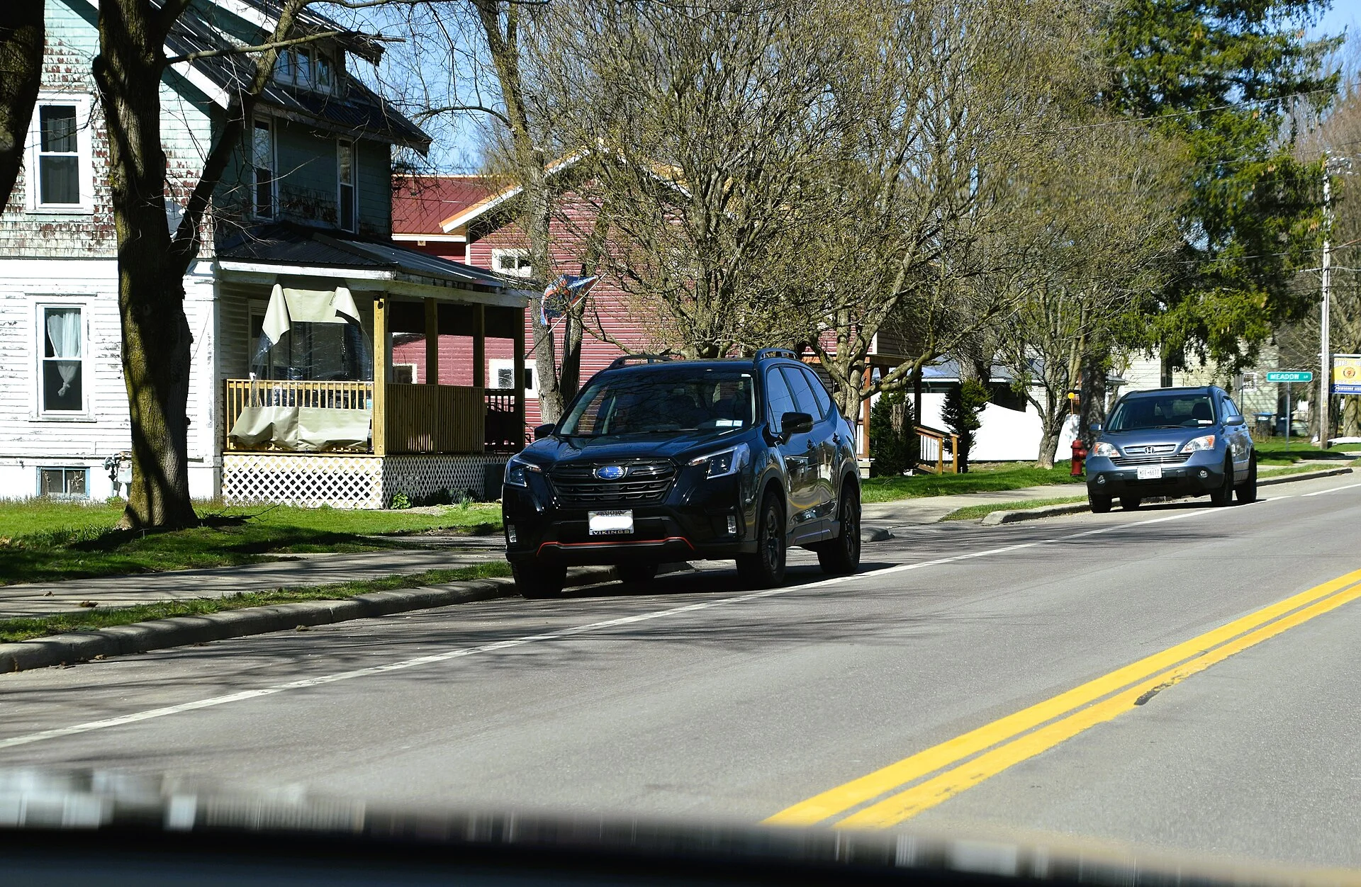 Subaru Forester Sport — a dark-green 2022 Forester, front three-quarter view