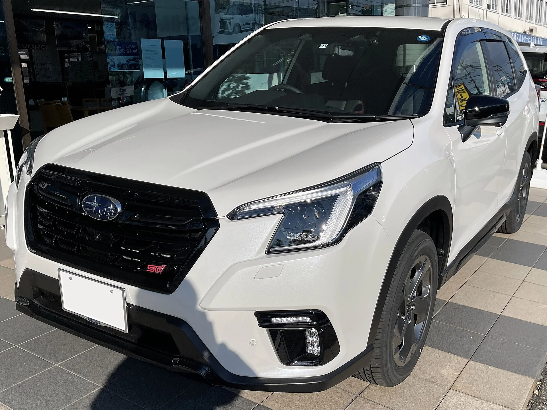 Subaru Forester STI Sport — a white 2022 Forester, front three-quarter view