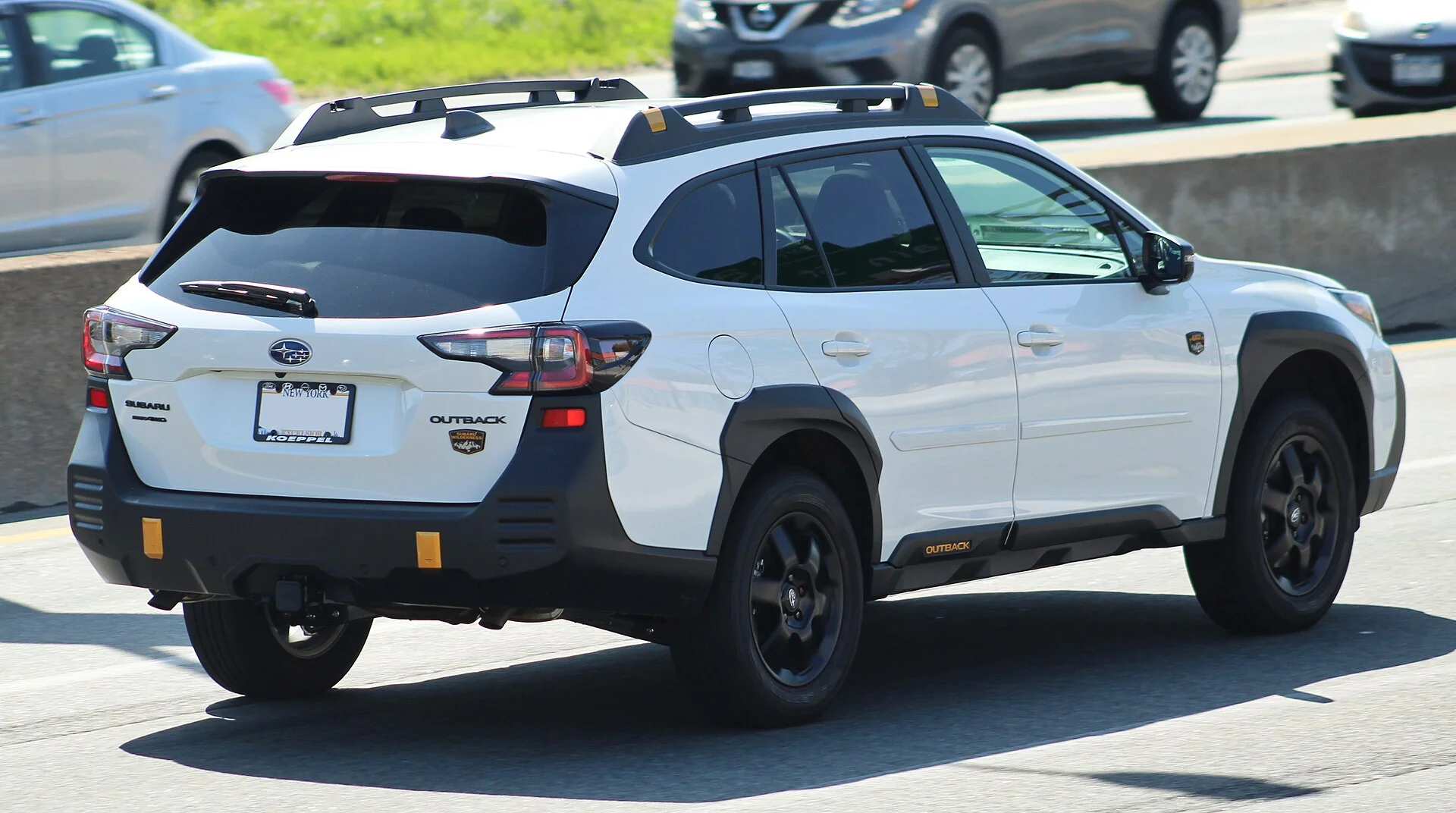 Subaru Outback Wilderness — a white 2022 Outback, rear three-quarter view