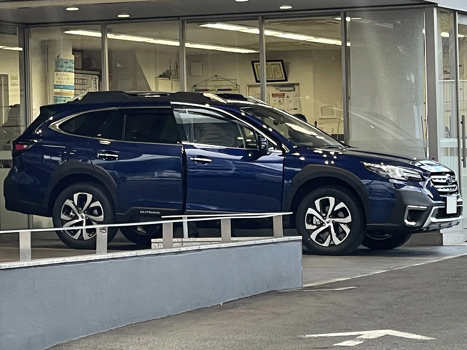 Subaru Outback Limited — a blue 2021 Outback, rear three-quarter view