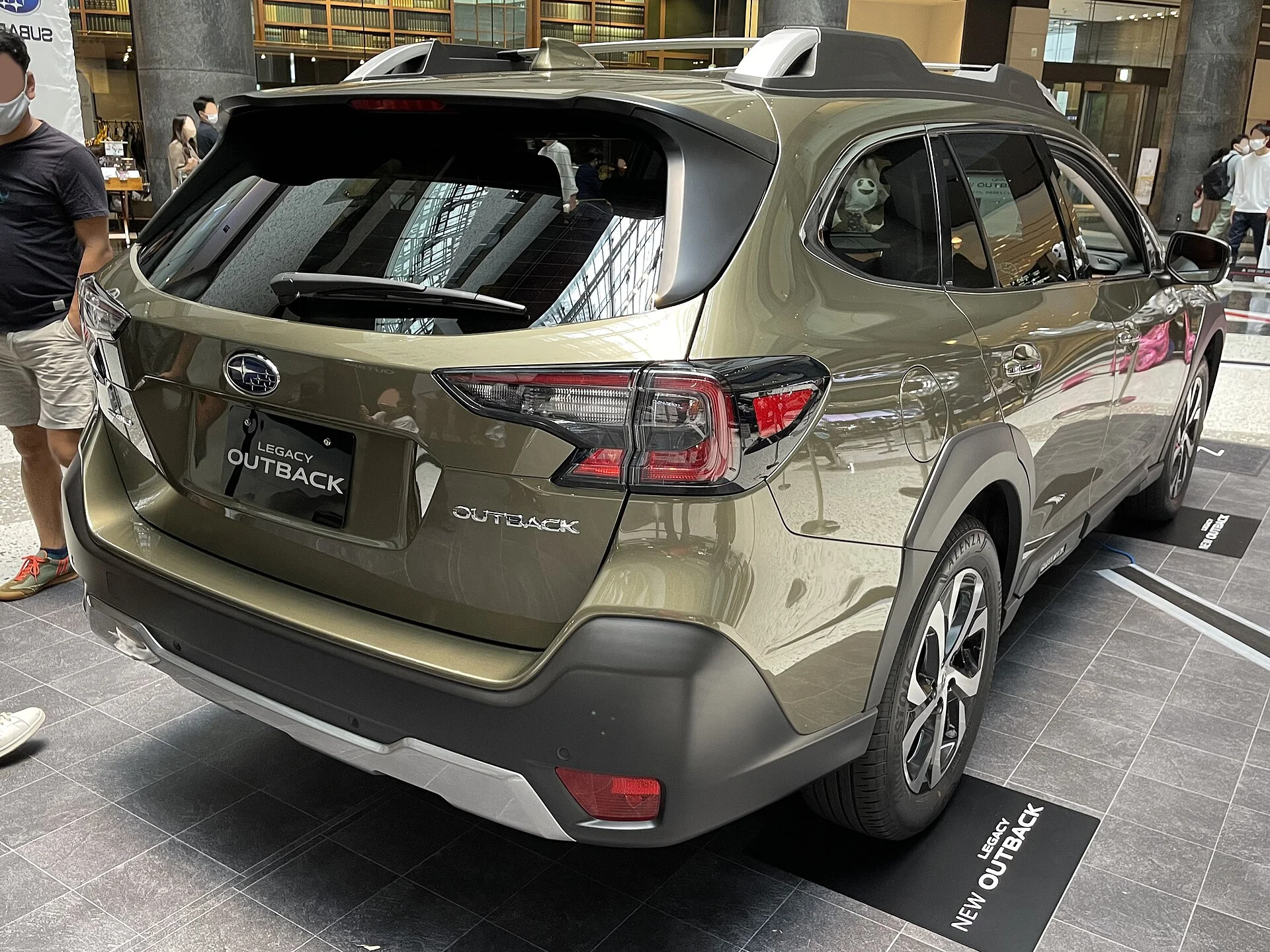 Subaru Outback Limited — an olive-green 2021 Outback, rear three-quarter view
