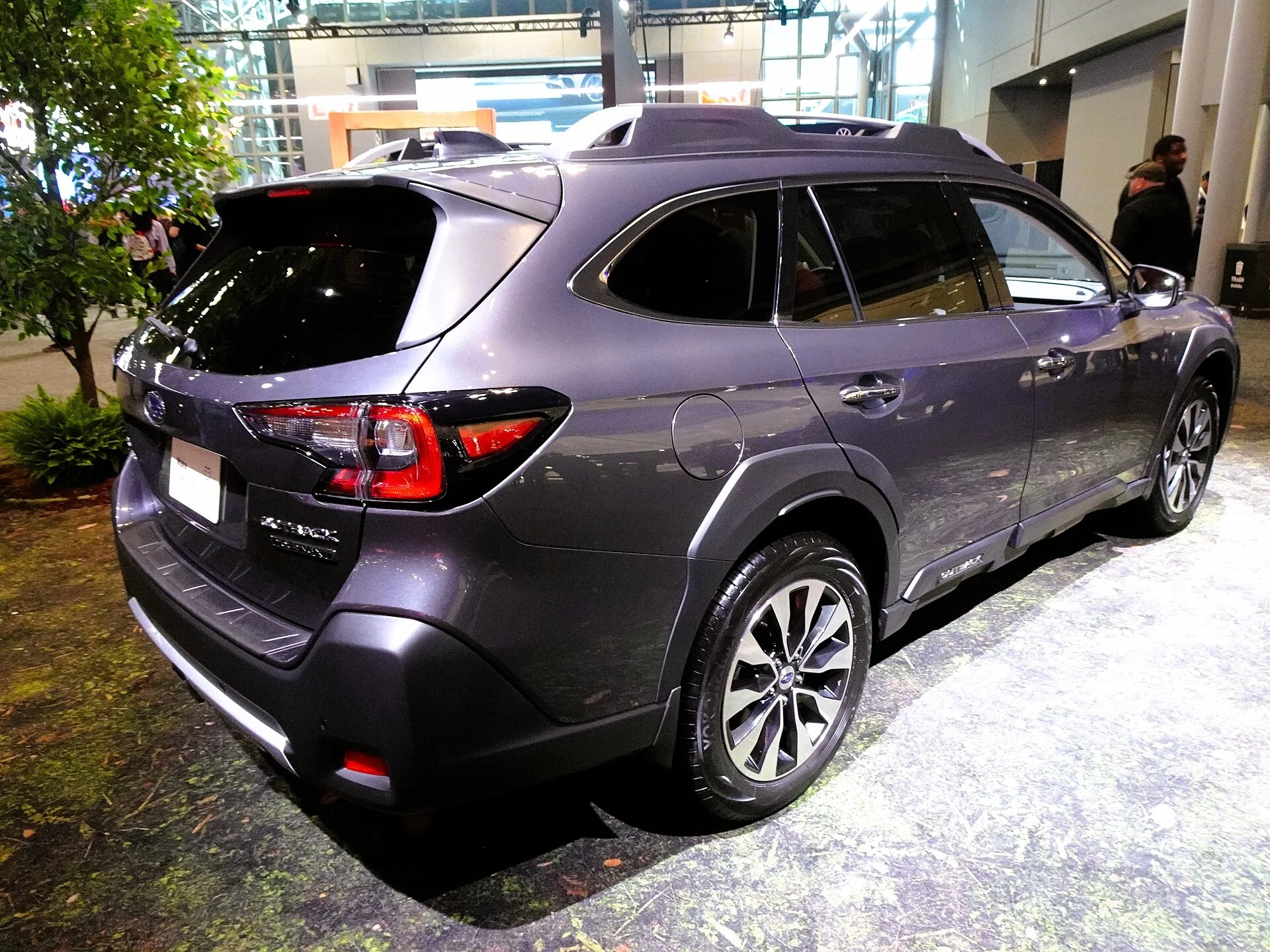 Grey-purple 2024 Subaru Outback Touring XT wagon (sixth generation), rear three-quarter view where a trailer hitch receiver mounts
