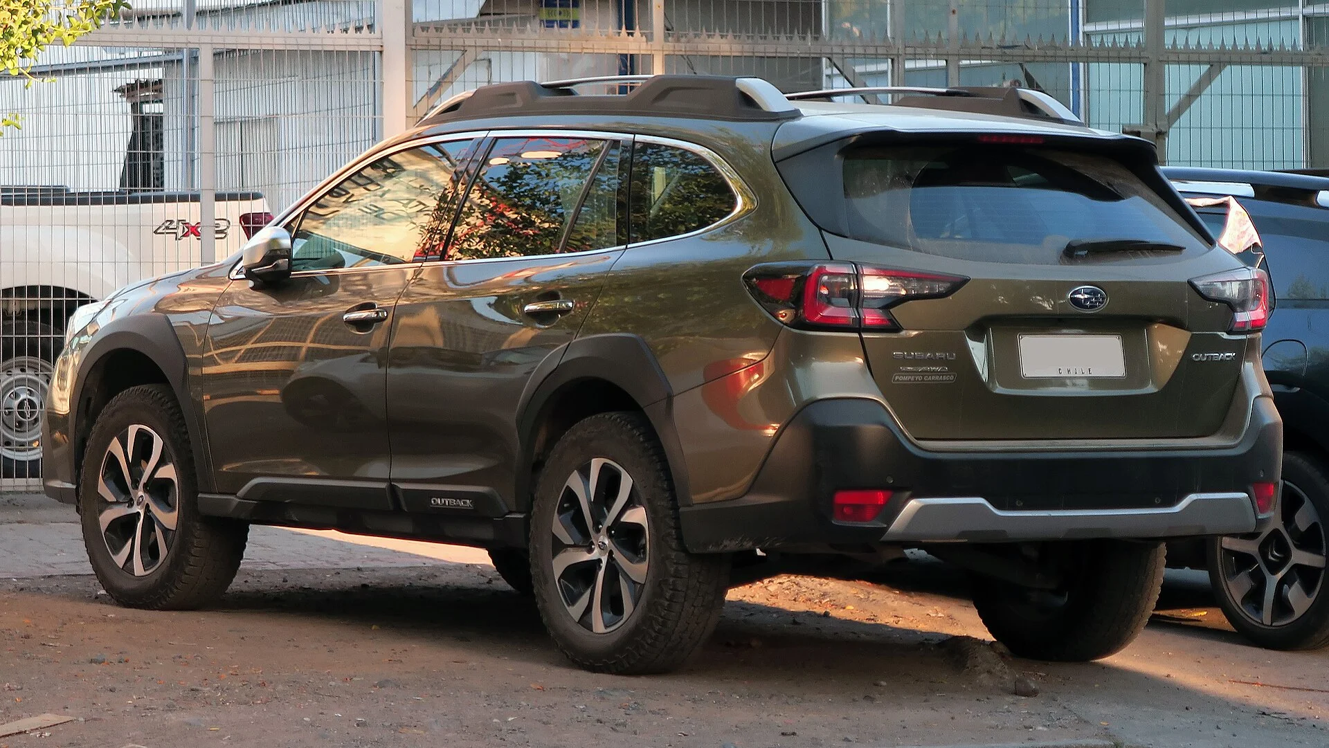 Subaru Outback Touring — a green 2021 Outback, rear three-quarter view (the cargo area behind the seats)