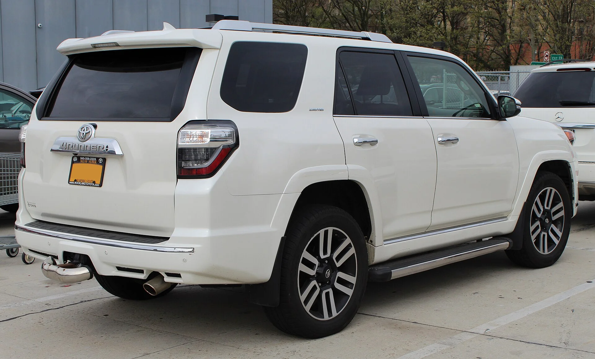 Toyota 4Runner Limited — a white 2014 4Runner, rear three-quarter view (the cargo area used for a sleeping platform)