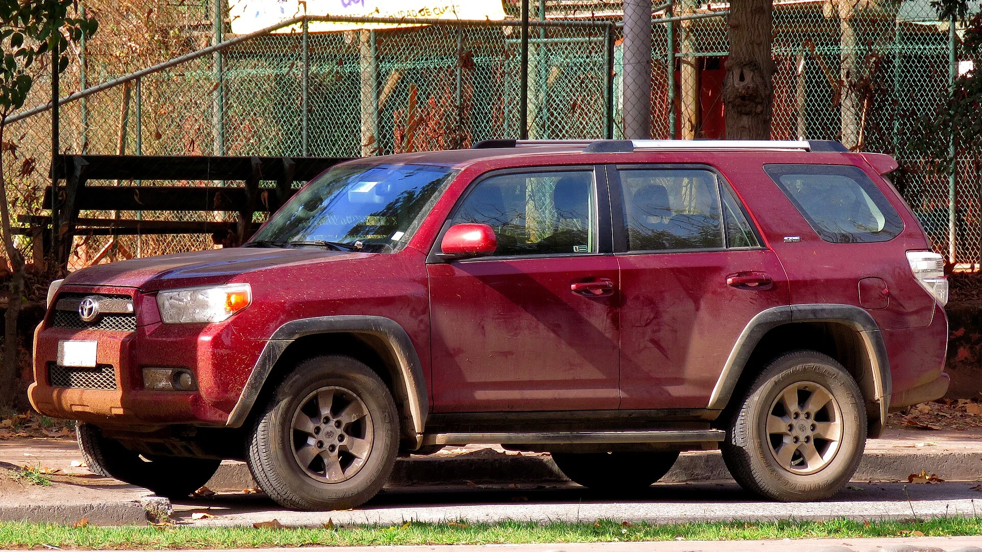 Toyota 4Runner SR5 — a maroon 2012 4Runner on a trail, side profile