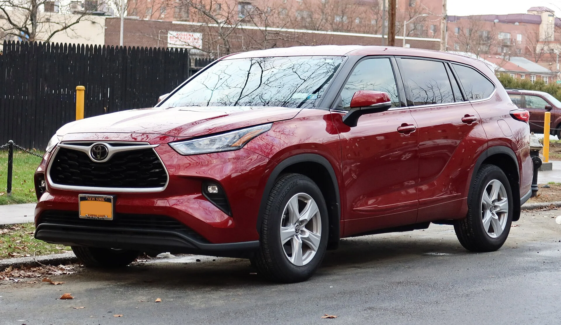 Toyota Highlander LE — a red 2020 Highlander, front three-quarter view with roof rails