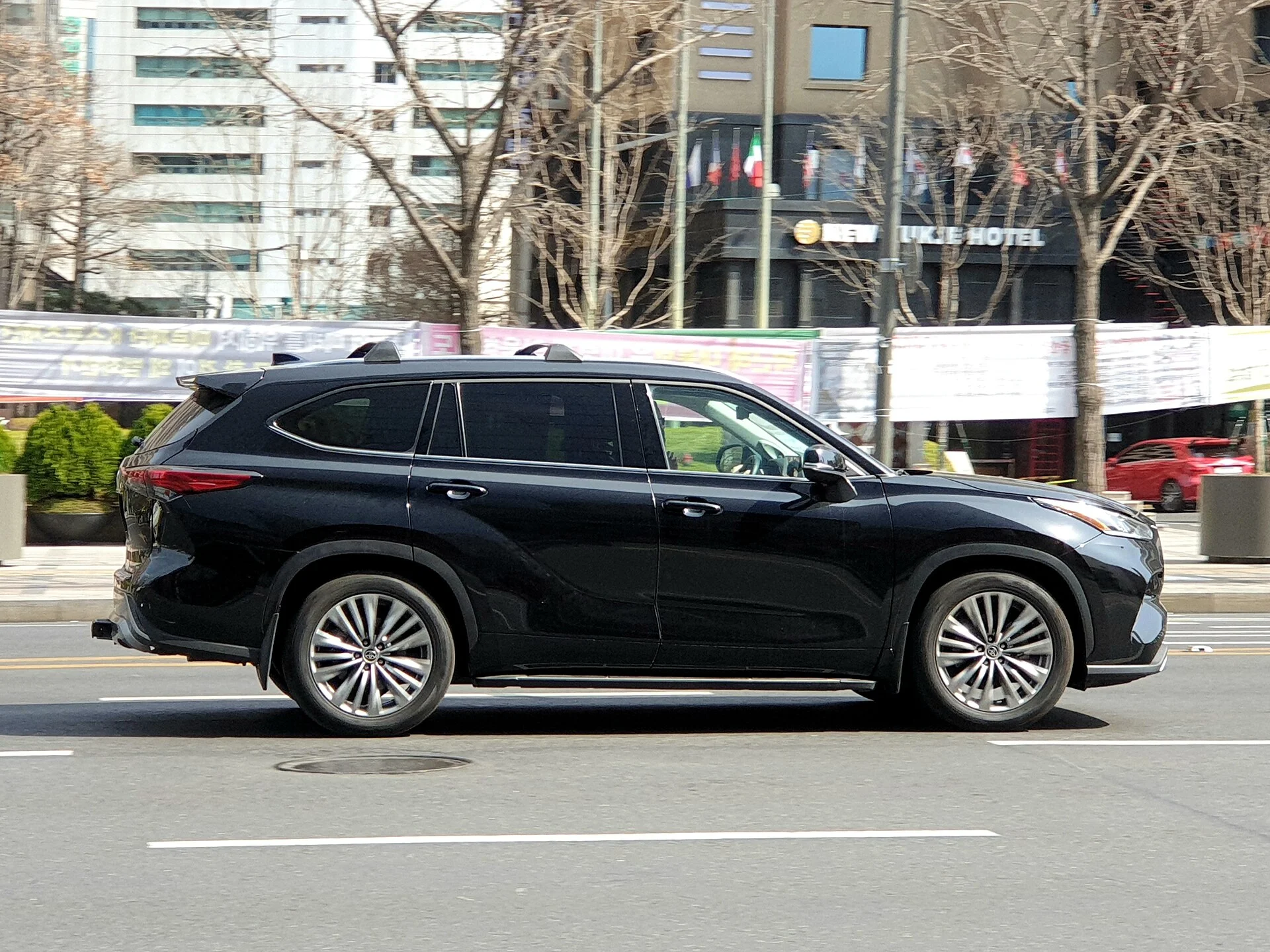 Toyota Highlander Platinum — a black Highlander, side profile showing the roof rails
