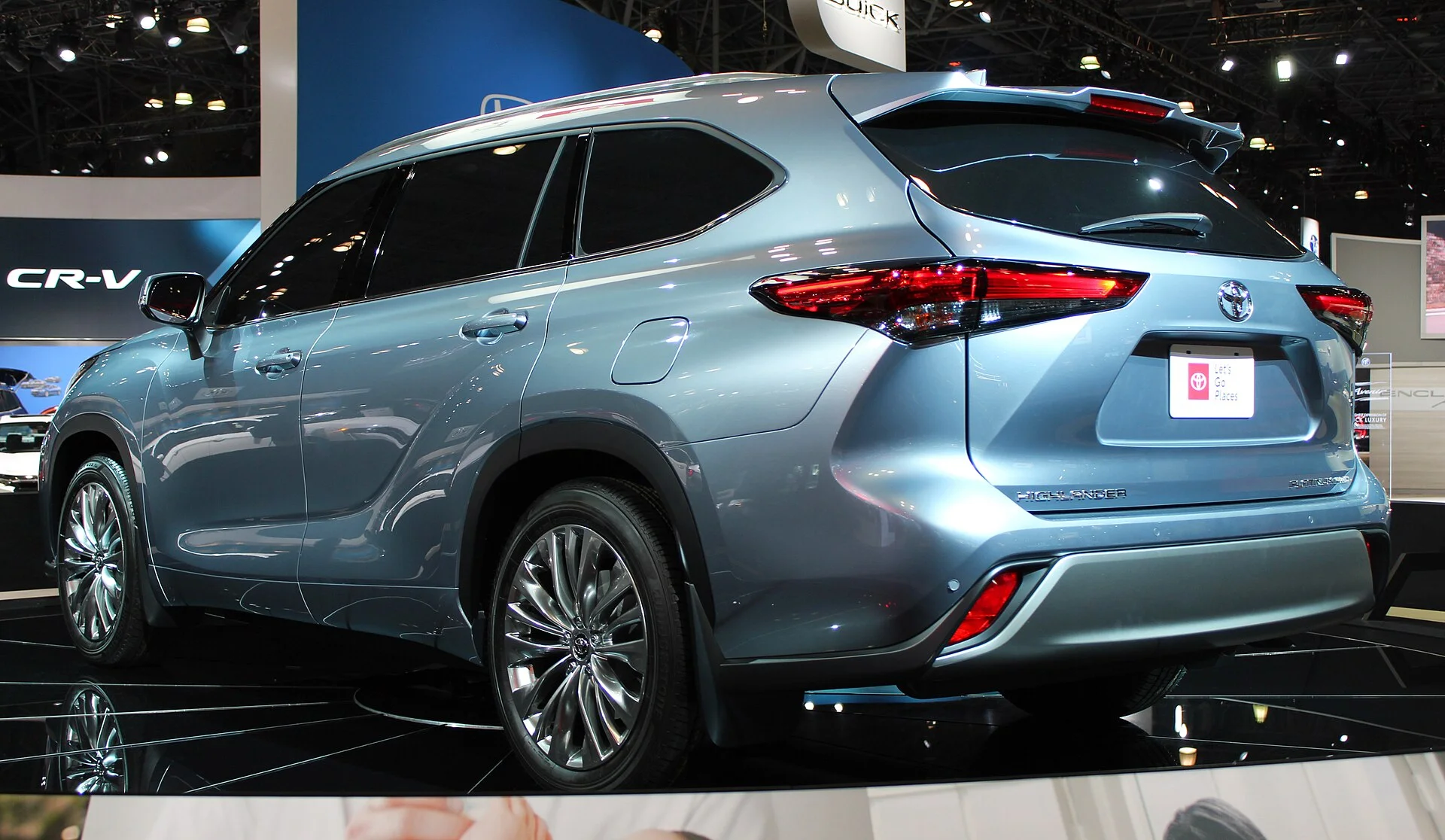 Toyota Highlander Platinum — a light-blue 2020 Highlander, rear three-quarter view with roof rails