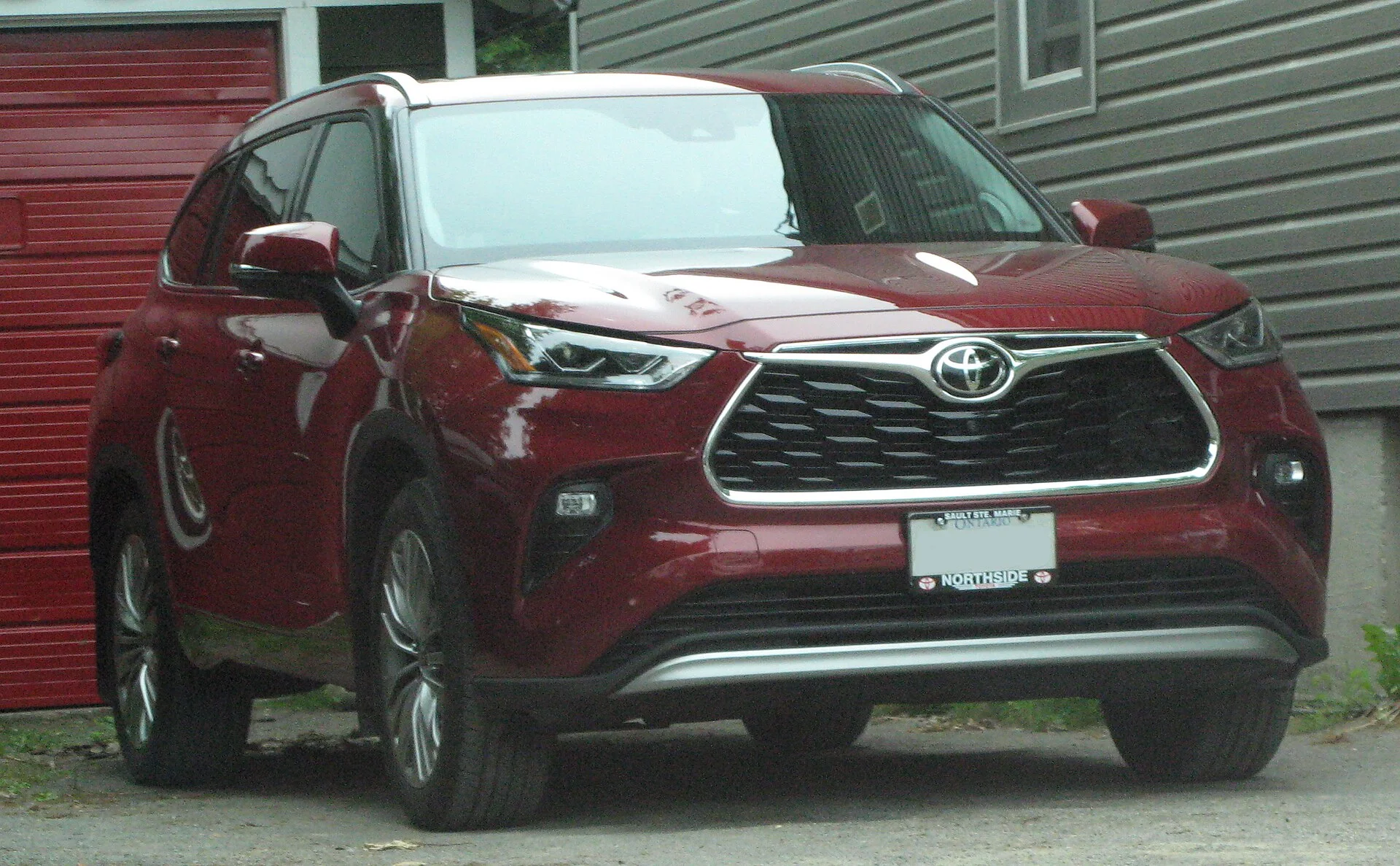 Toyota Highlander Platinum — a maroon 2020 Highlander, front three-quarter view