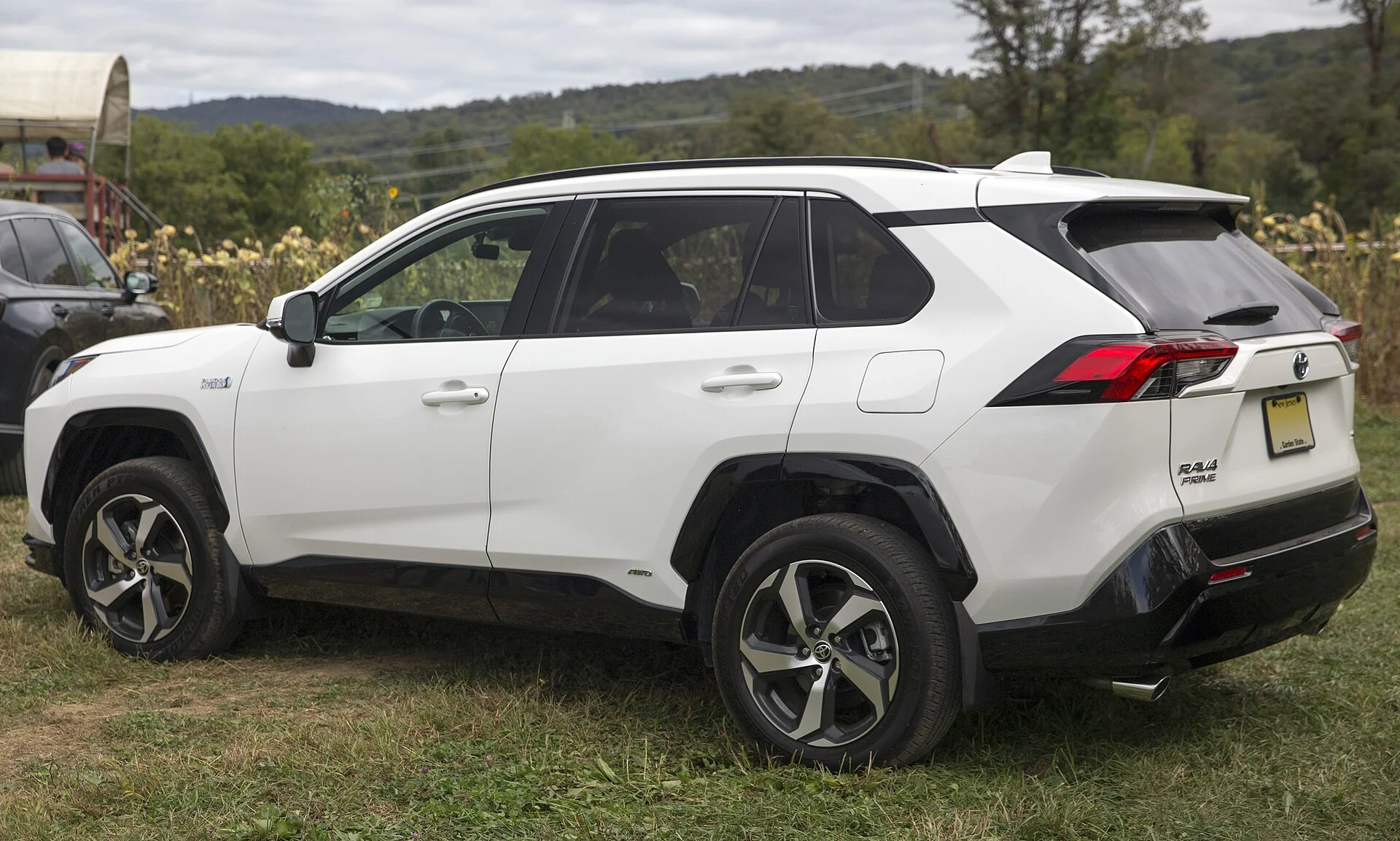 White (Ice Cap) Toyota RAV4 Prime, rear three-quarter