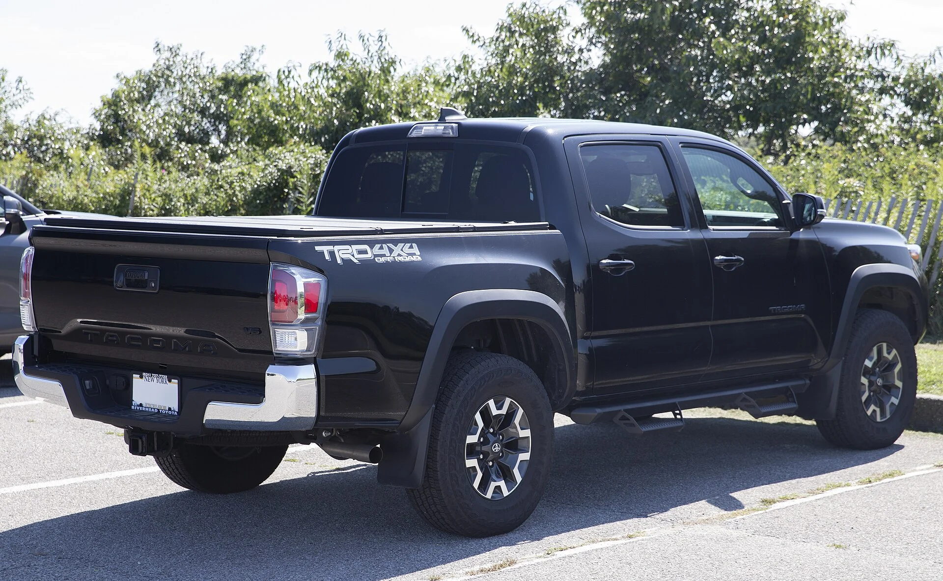 Toyota Tacoma TRD Off-Road — a black 2023 Tacoma, rear three-quarter view (the bed with the cargo tie-down points)