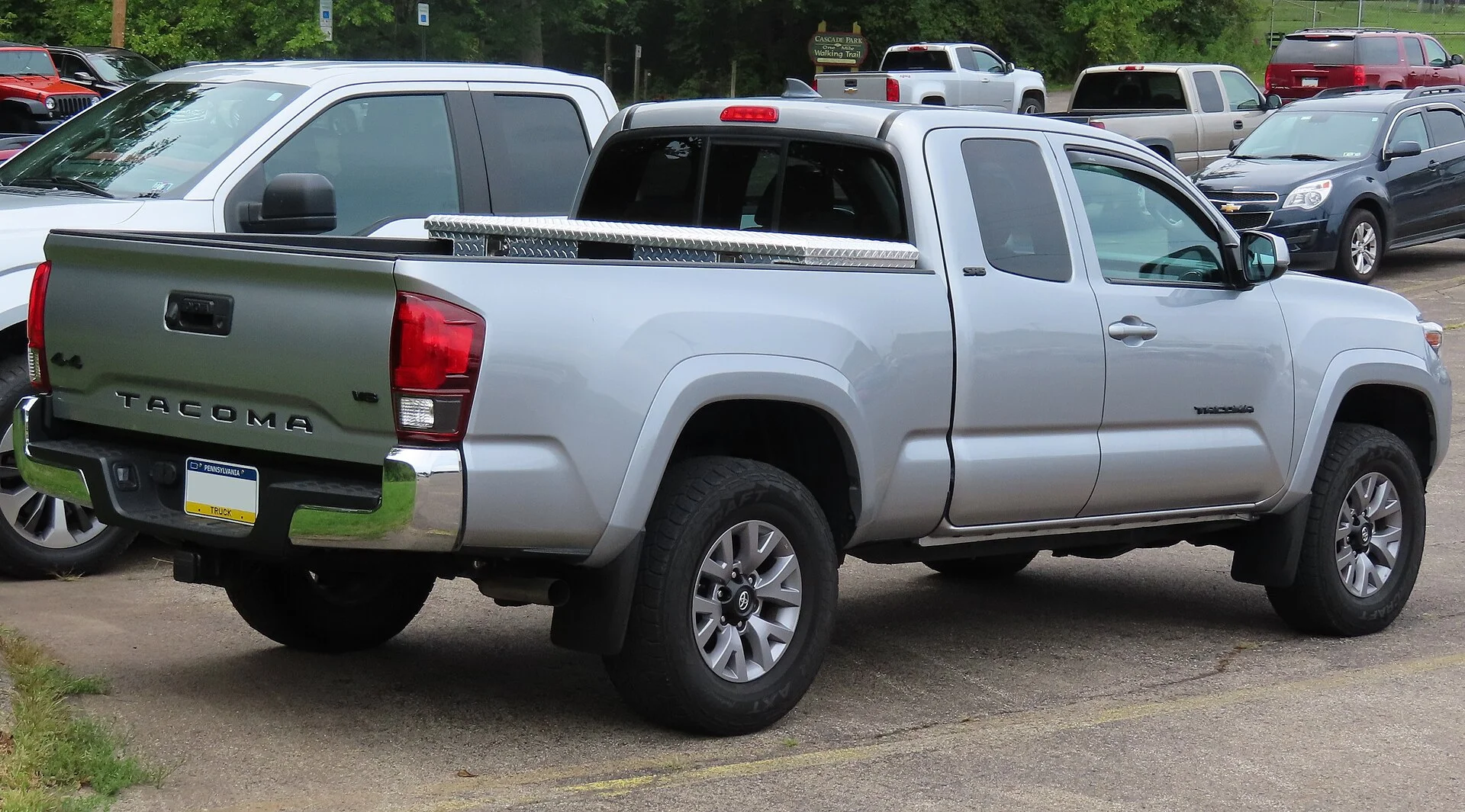 Toyota Tacoma SR5 — a silver 2019 Tacoma, rear three-quarter view (the bed used for cargo)