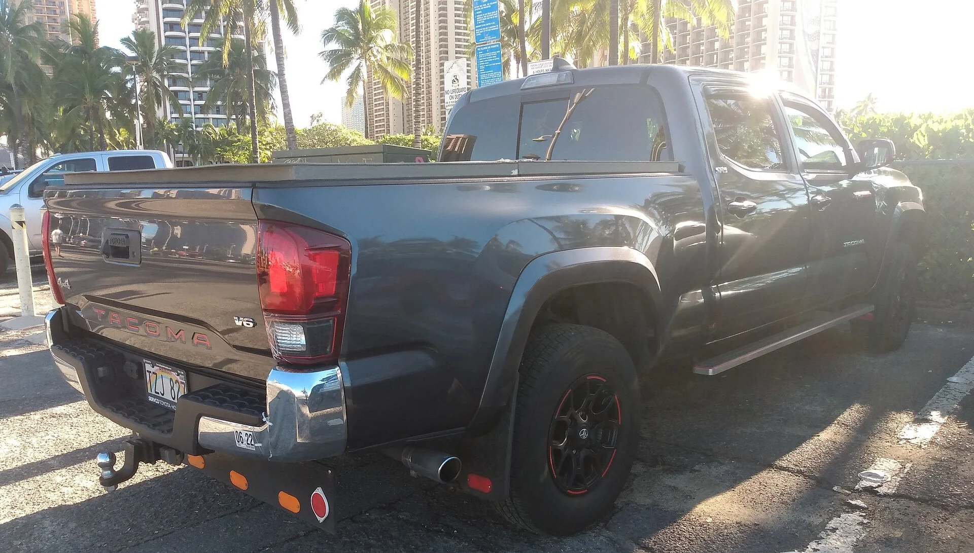 Dark grey 2021 Toyota Tacoma V6 pickup (third generation), rear three-quarter view showing the bed used for payload