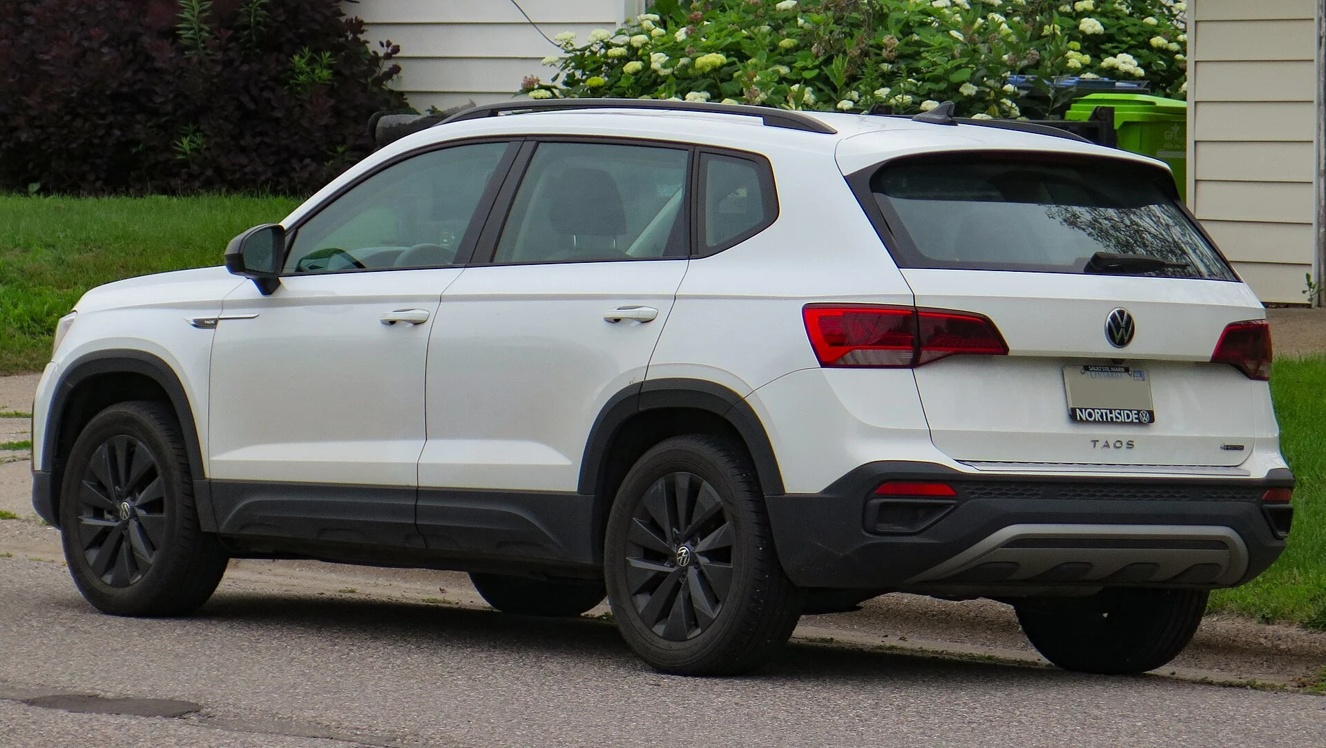 A VW Taos in white (side profile), showing the length available for a Taos car camping sleeping setup.