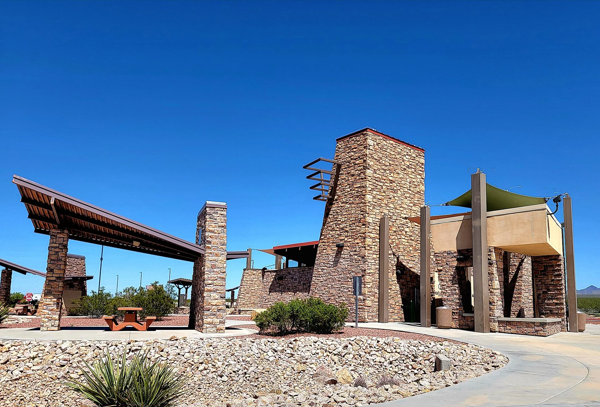 A modern interstate rest area building and lot, where posted signs tell you exactly how long you may stay