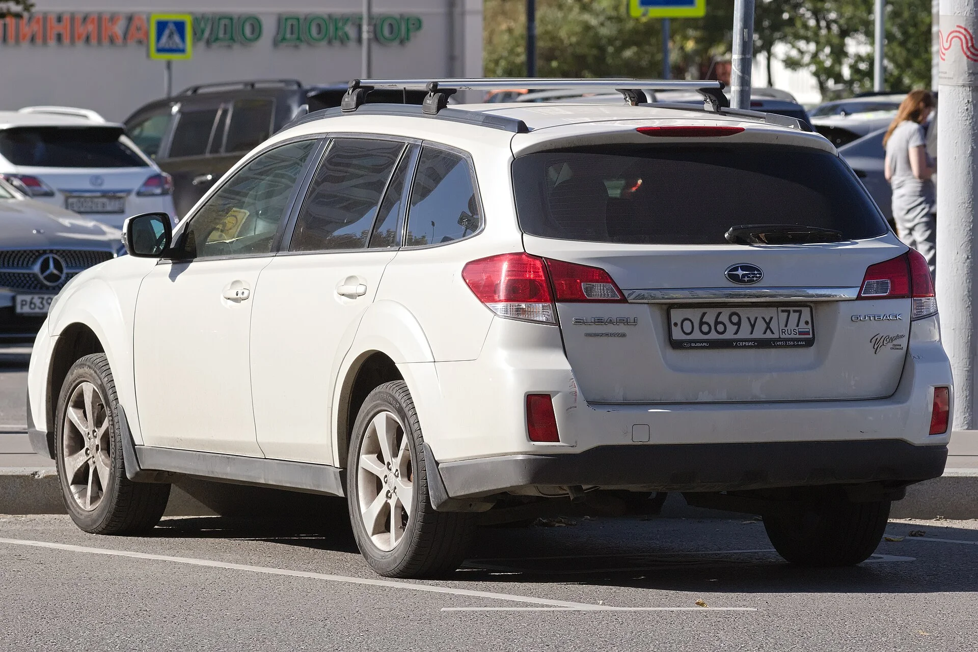 White Subaru Outback, rear three-quarter view with roof rails