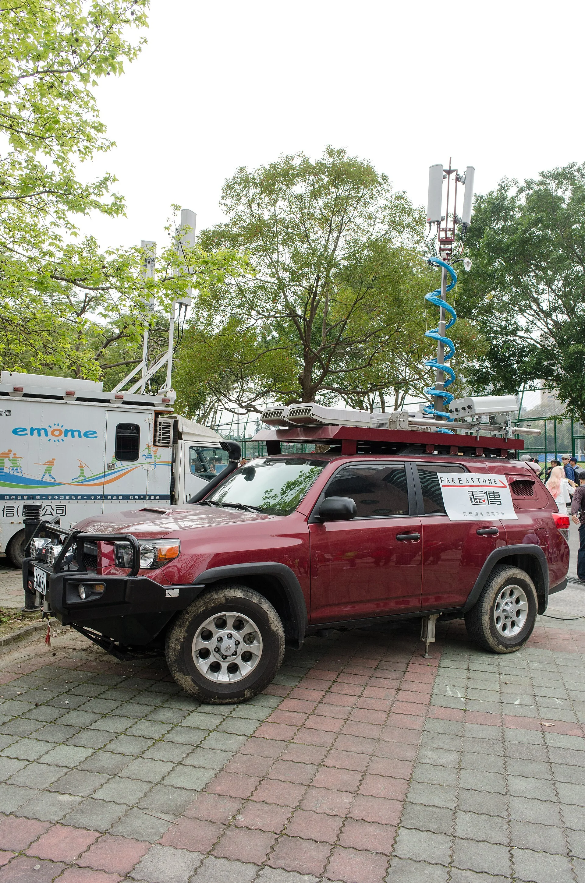 Red Toyota 4Runner with a loaded roof rack, side view