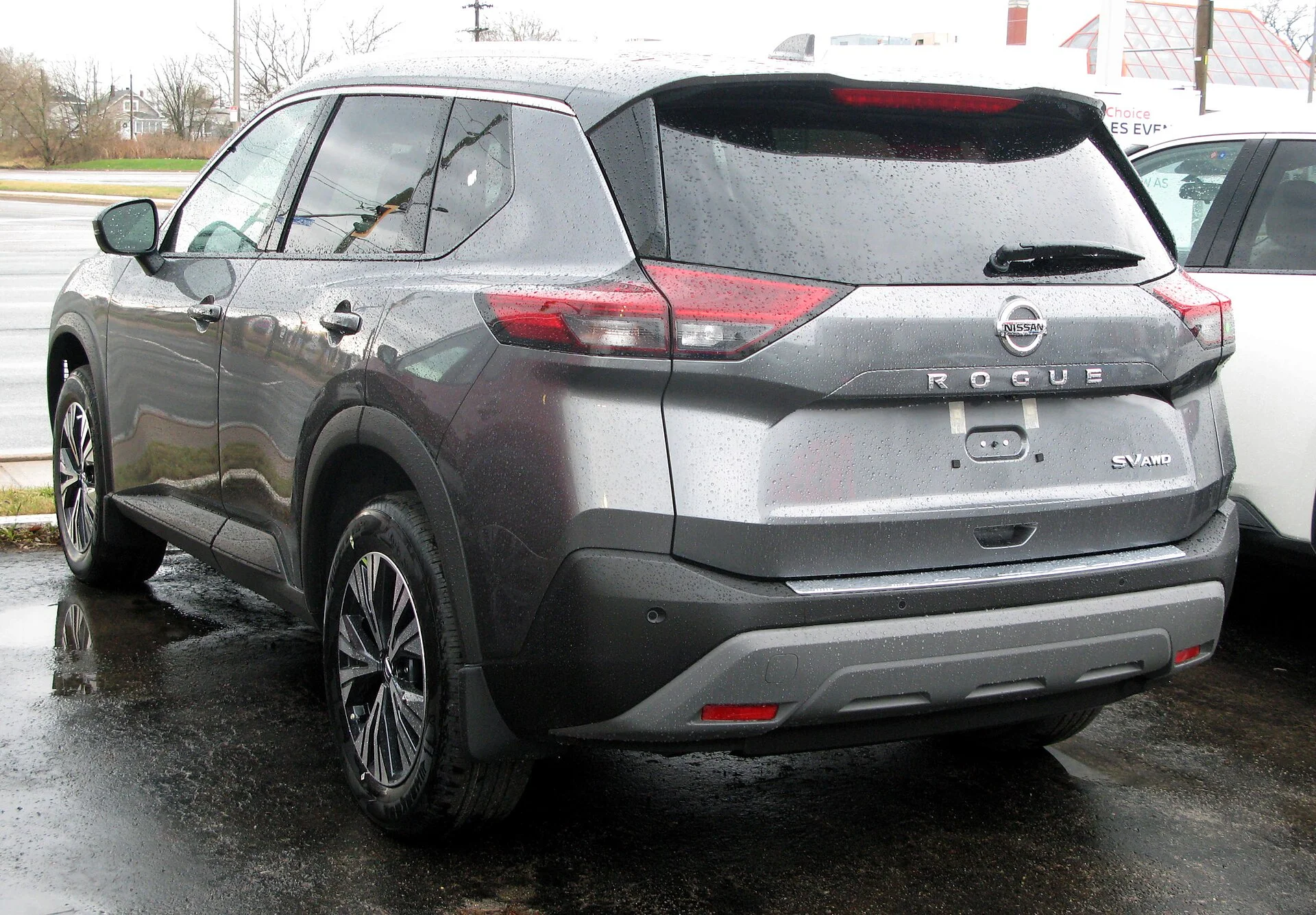 A grey Nissan Rogue seen from the rear