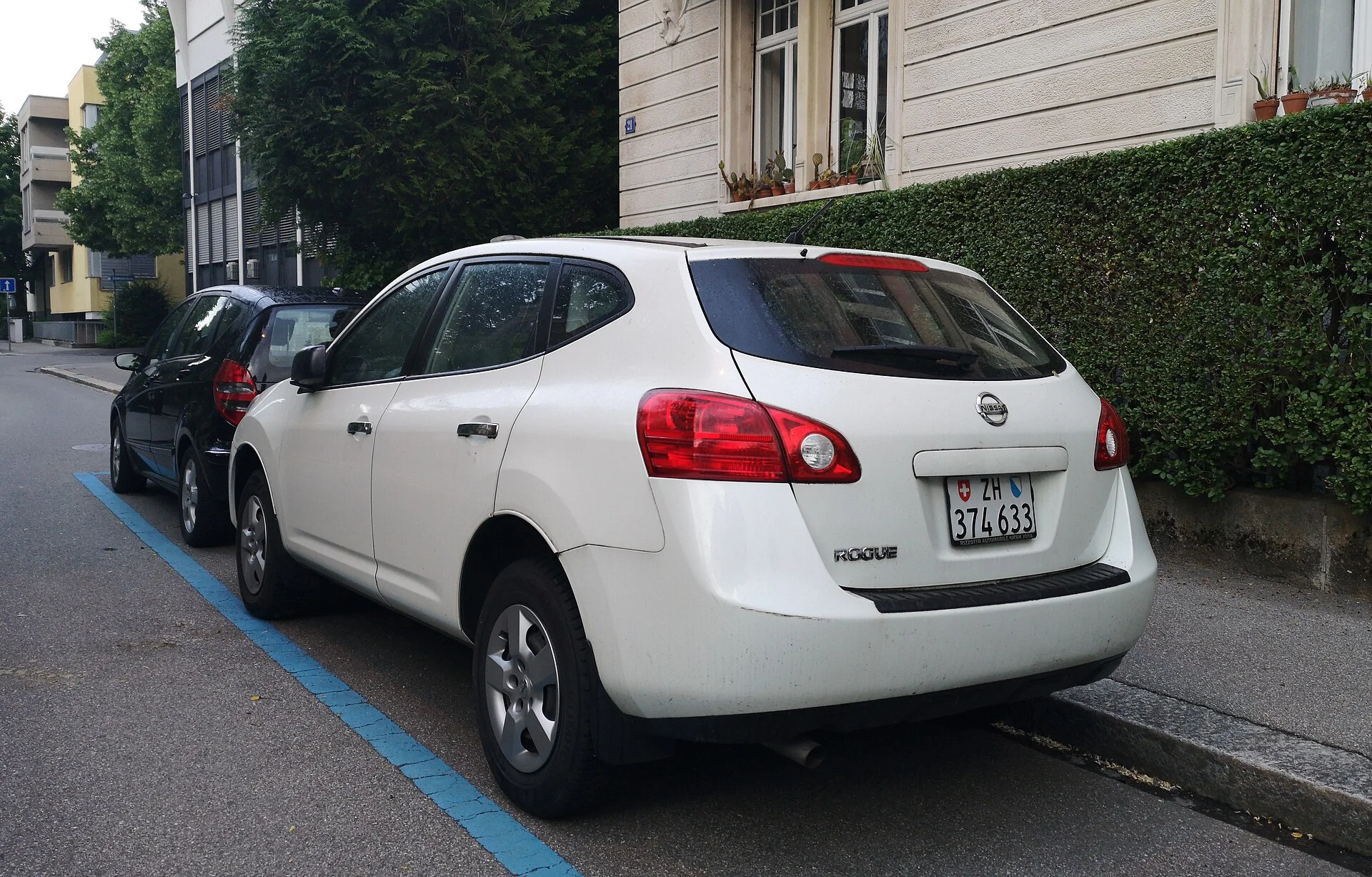 A white 2011 Nissan Rogue side profile