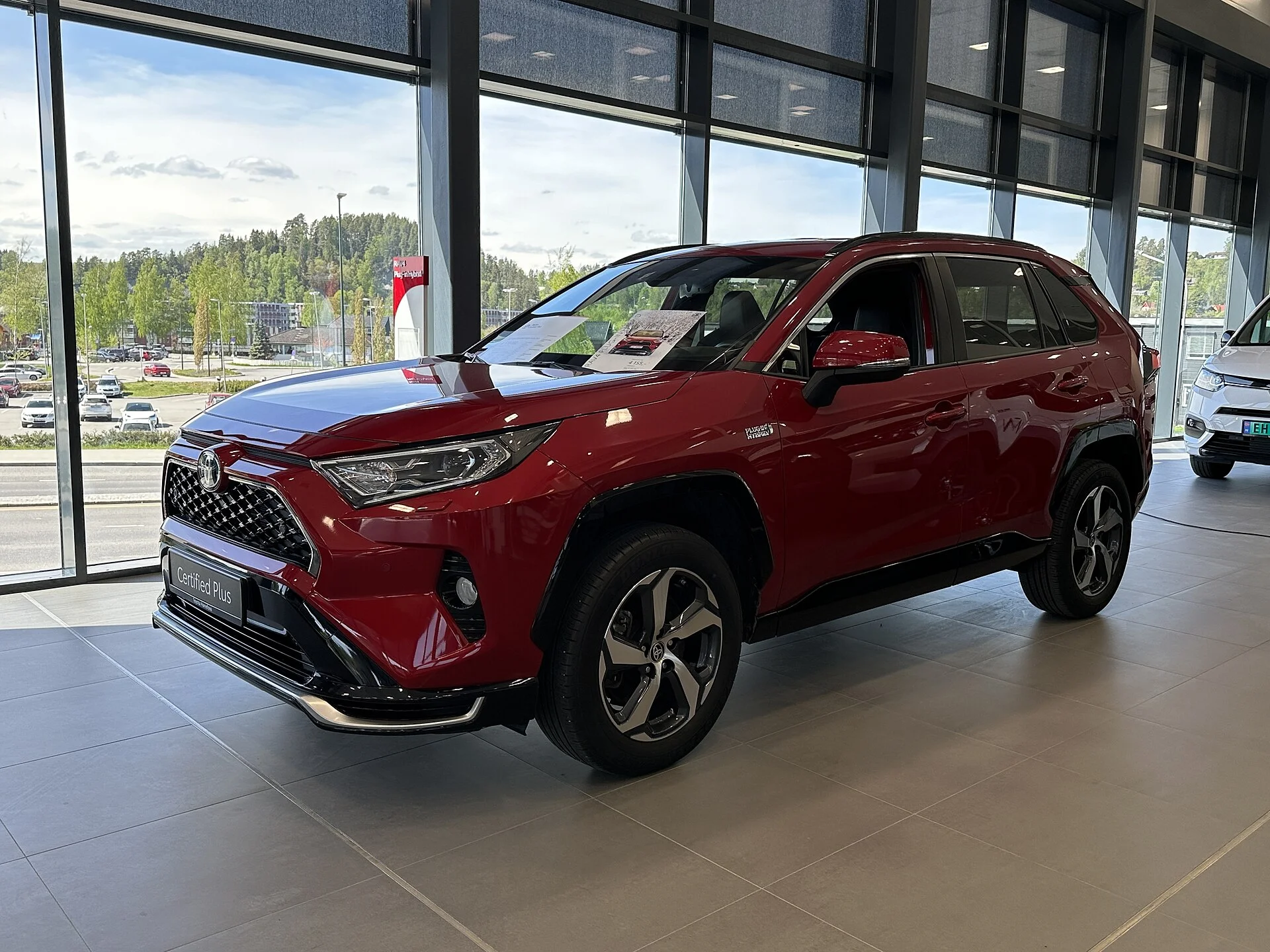 Red Toyota RAV4, current generation, front three-quarter view