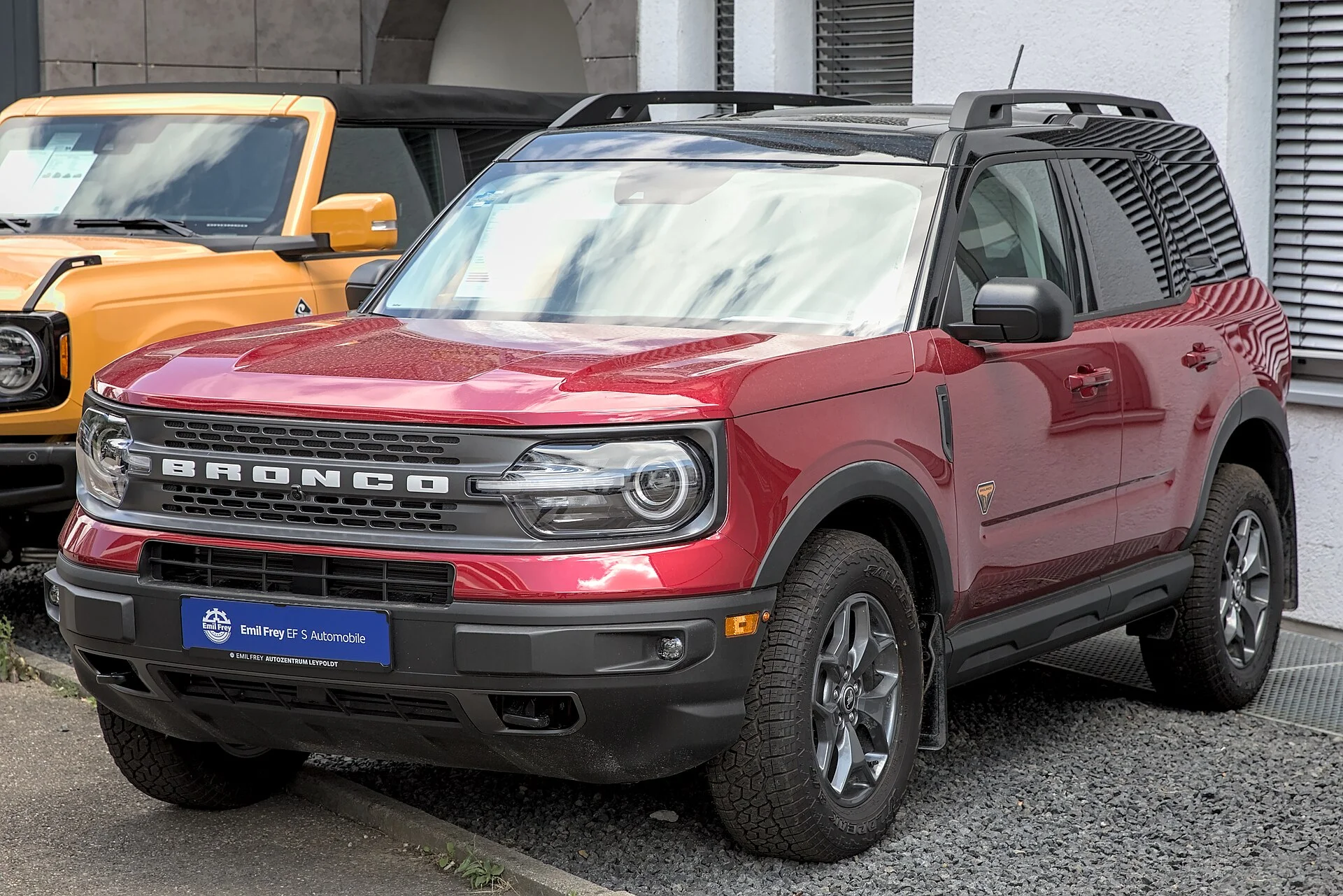 Ford Bronco Sport Badlands in red, front three-quarter view showing the roof rails