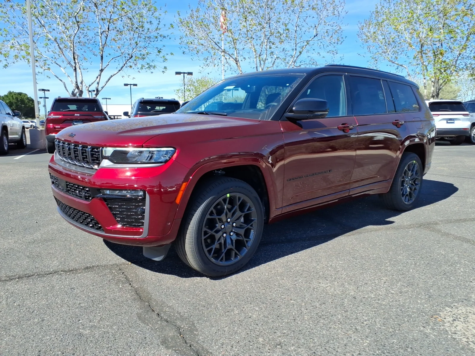 Maroon Jeep Grand Cherokee L, current generation, side view