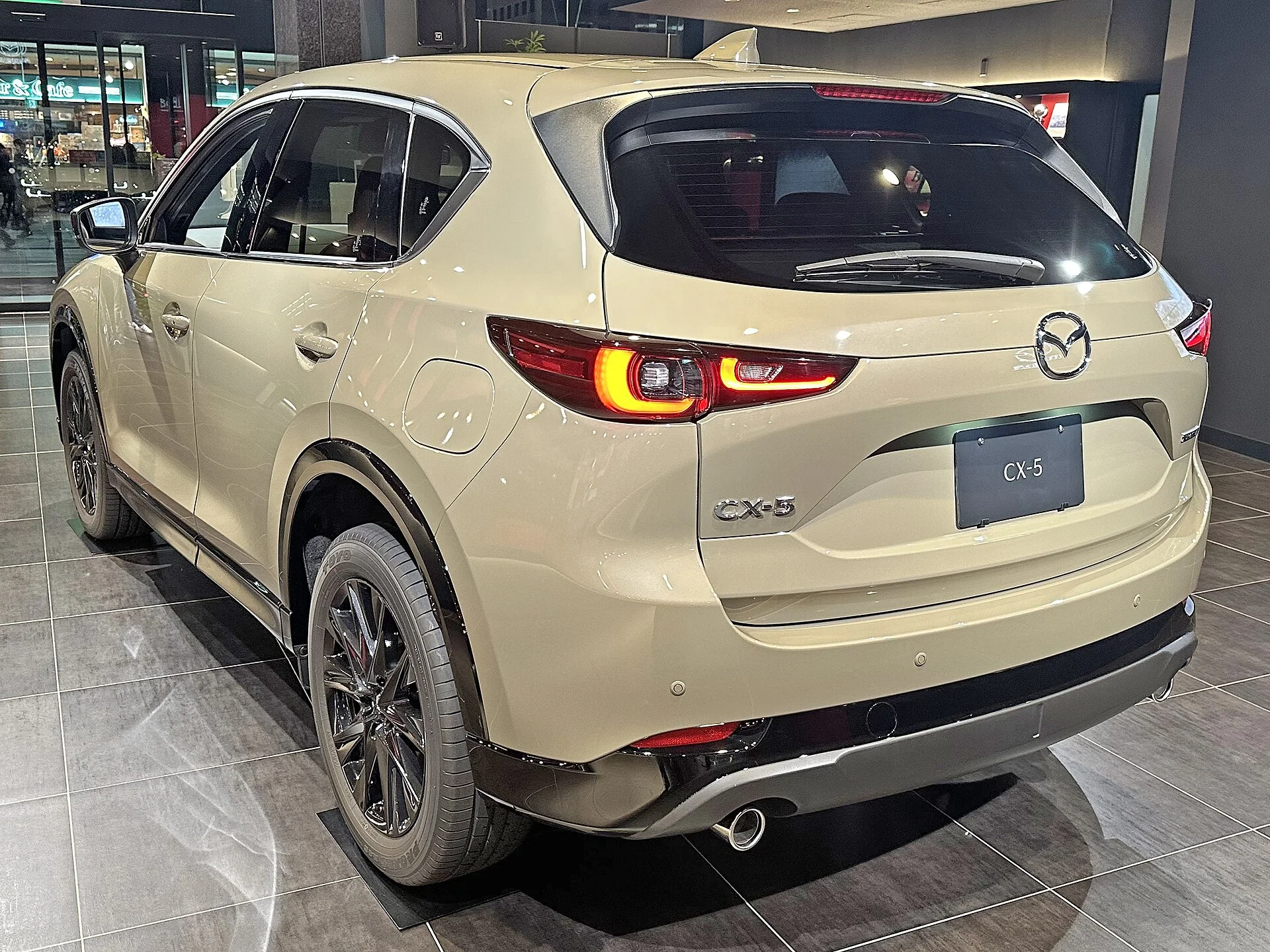 A beige Mazda CX-5 seen from the rear